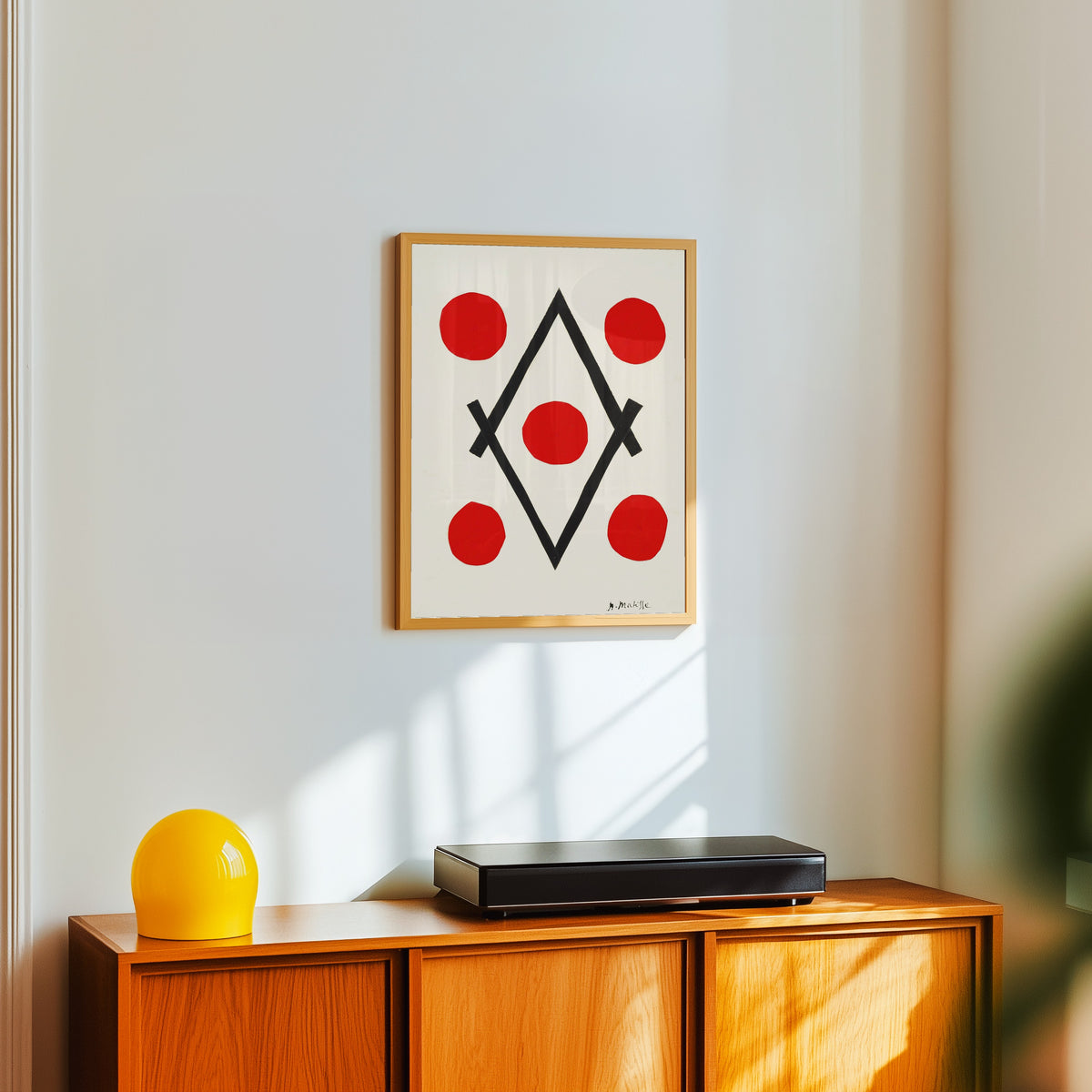 Framed art print of Losange by Henri Matisse, in a light wood frame on a white wall above an orange sideboard