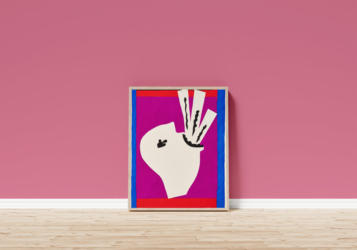 Framed art print of The Sword Swallower by Henri Matisse, in a light wood frame leaning on a pink wall above a wooden floor