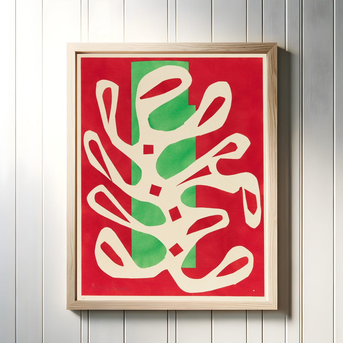 Framed art print of White Algae on Red and Green Ground by Henri Matisse, in a light wood frame on a white panelled wall