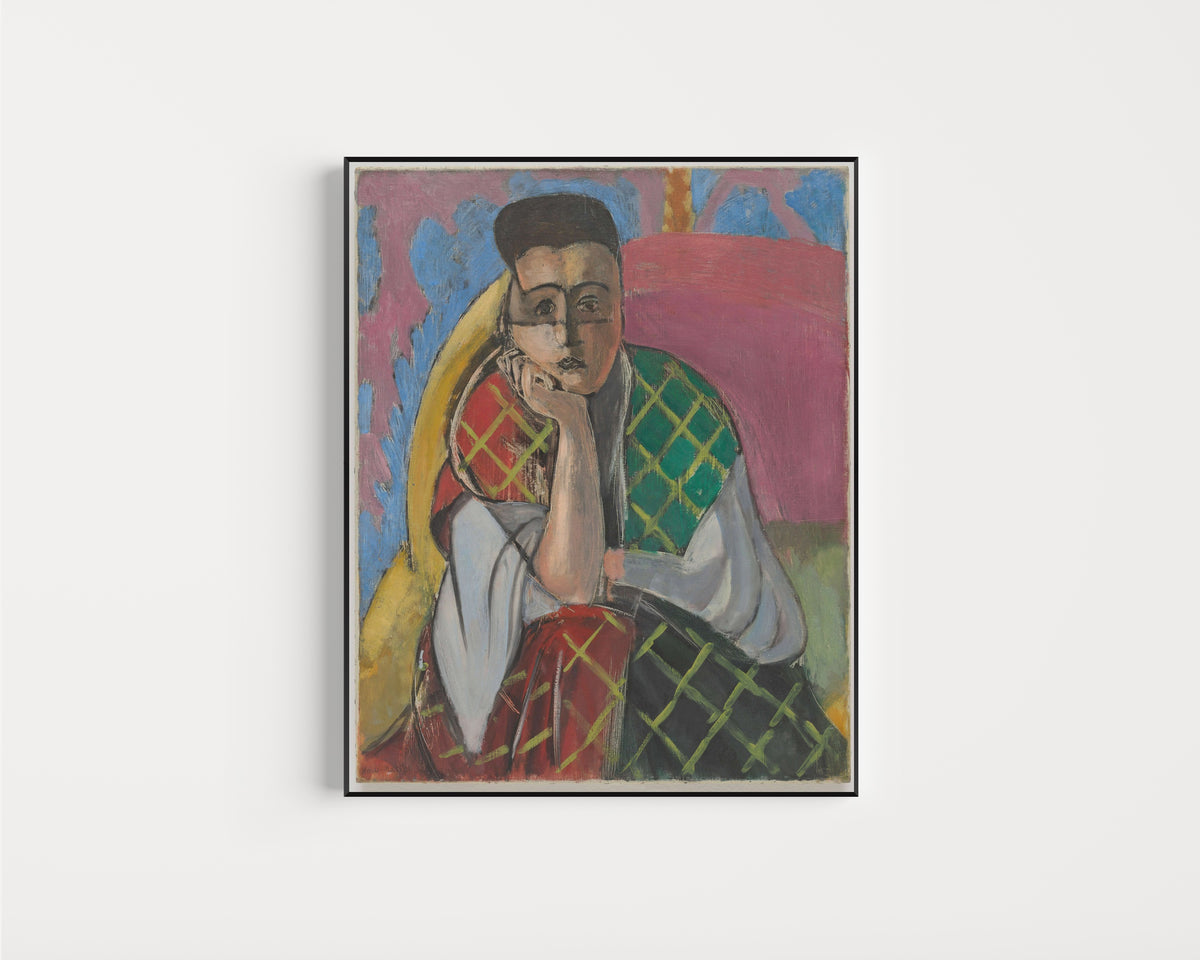 Framed art print of Woman with a Veil by Henri Matisse, in a slim black frame on a plain white wall
