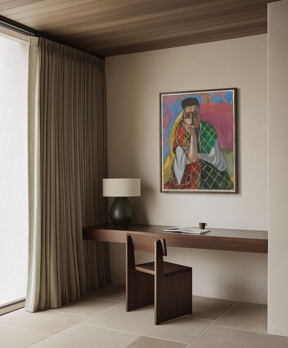 Framed art print of Woman with a Veil by Henri Matisse, in a dark wood frame on a plaster wall above a walnut desk