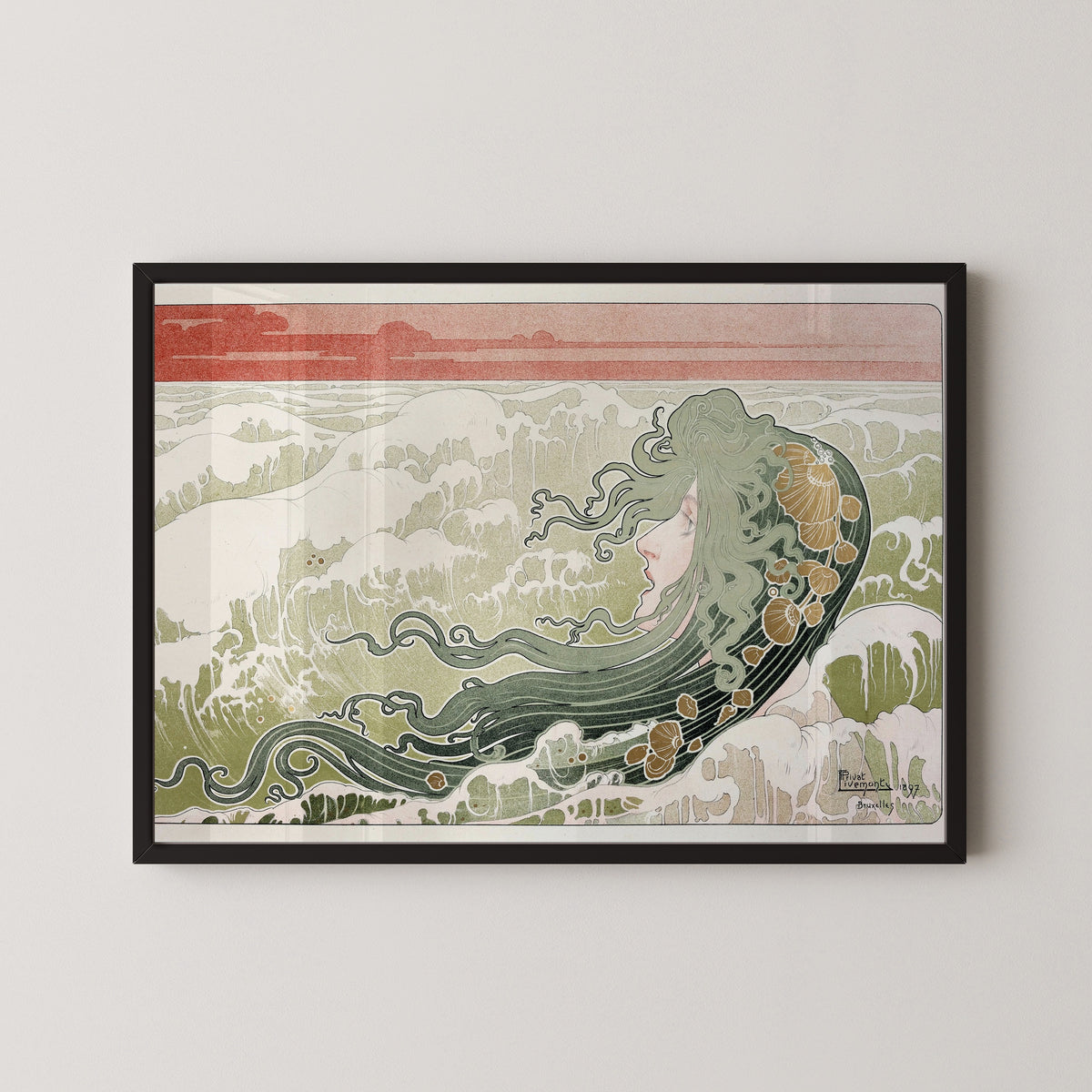 Framed art print of La Vague (The Wave) by Henri Privat-Livemont, in a black frame on a pale wall