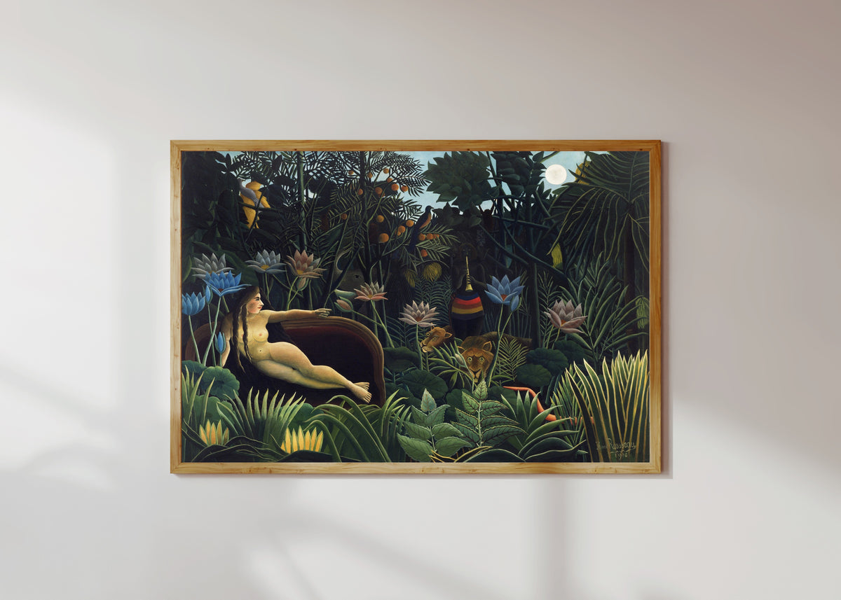 Framed art print of The Dream by Henri Rousseau, in a light wood frame on a sunlit white wall