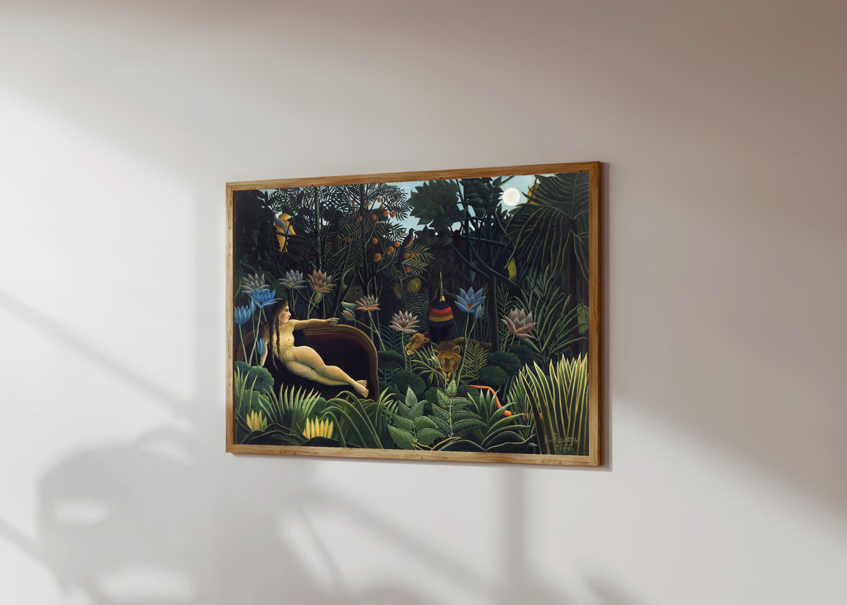 Framed art print of The Dream by Henri Rousseau, in a light wood frame on a sunlit white wall, seen at a slight angle