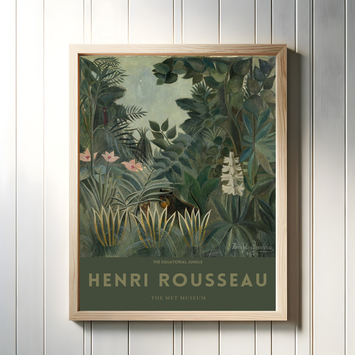 Framed art print of The Equatorial Jungle by Henri Rousseau, in a light wood frame on a white panelled wall