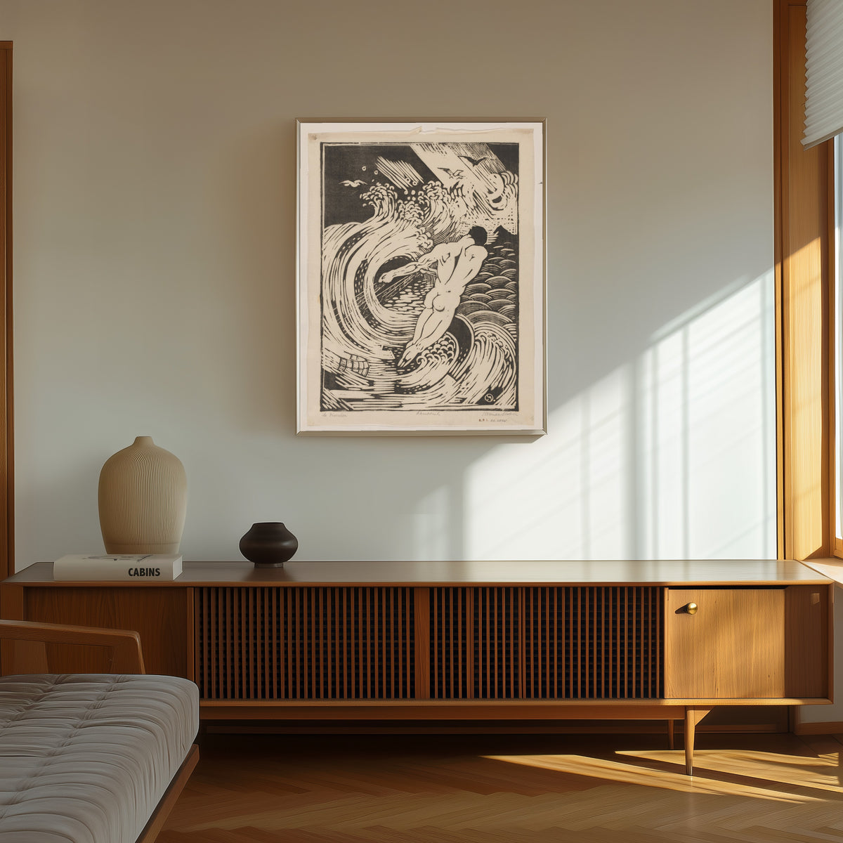 Framed art print of De visscher [The fisherman] by Henri van der Stok, in a thin light frame on a sunlit wall above a wooden sideboard