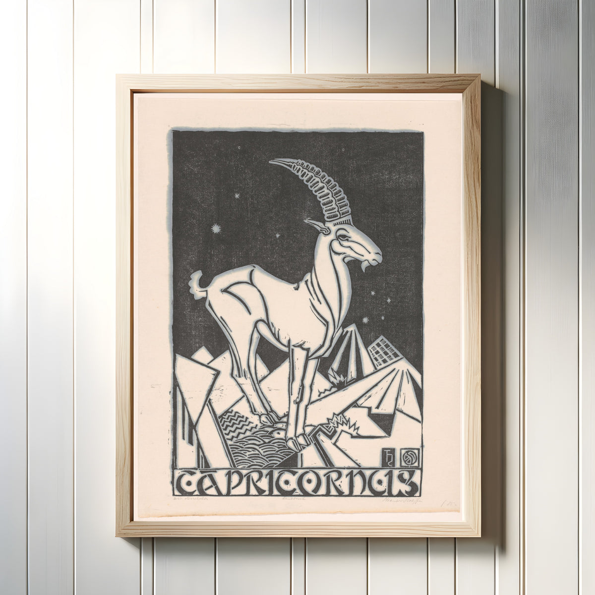 Framed art print of Sterrenbeeld steenbok [Zodiac sign Capricorn] by Henri van der Stok, in a light wood frame on a white panelled wall