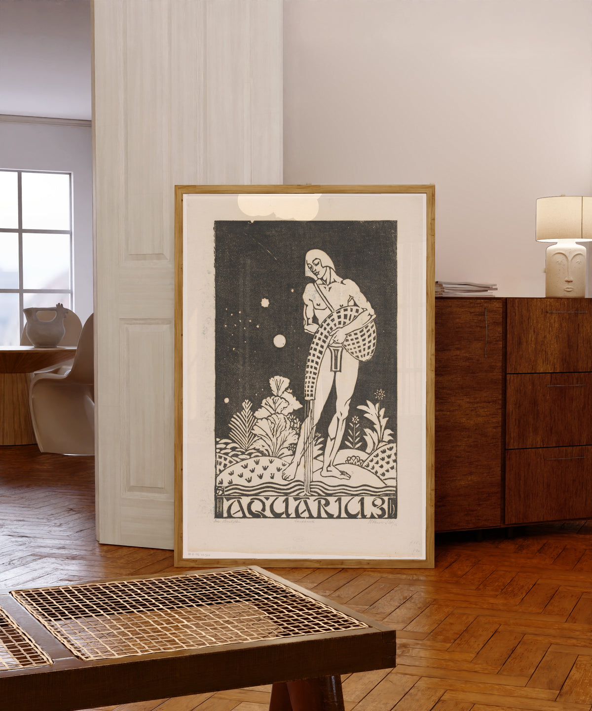 Framed art print of Sterrenbeeld waterman [Zodiac sign Aquarius] by Henri van der Stok, in a light wood frame leaning in a warm room with a parquet floor