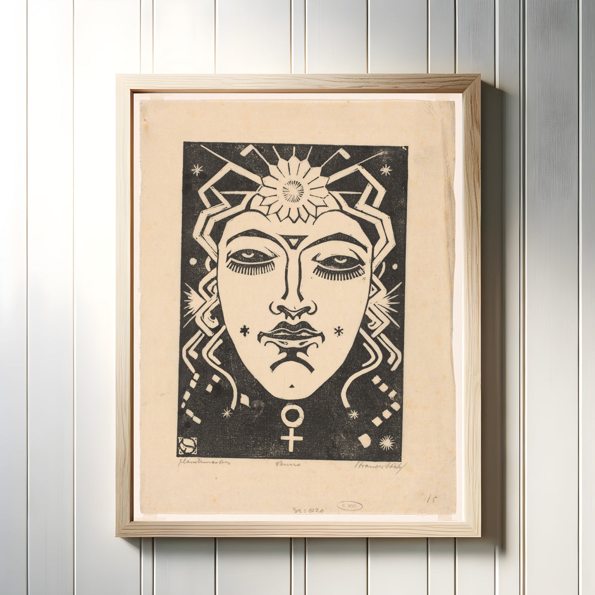 Framed art print of Venus by Henri van der Stok, in a light wood frame on a white panelled wall