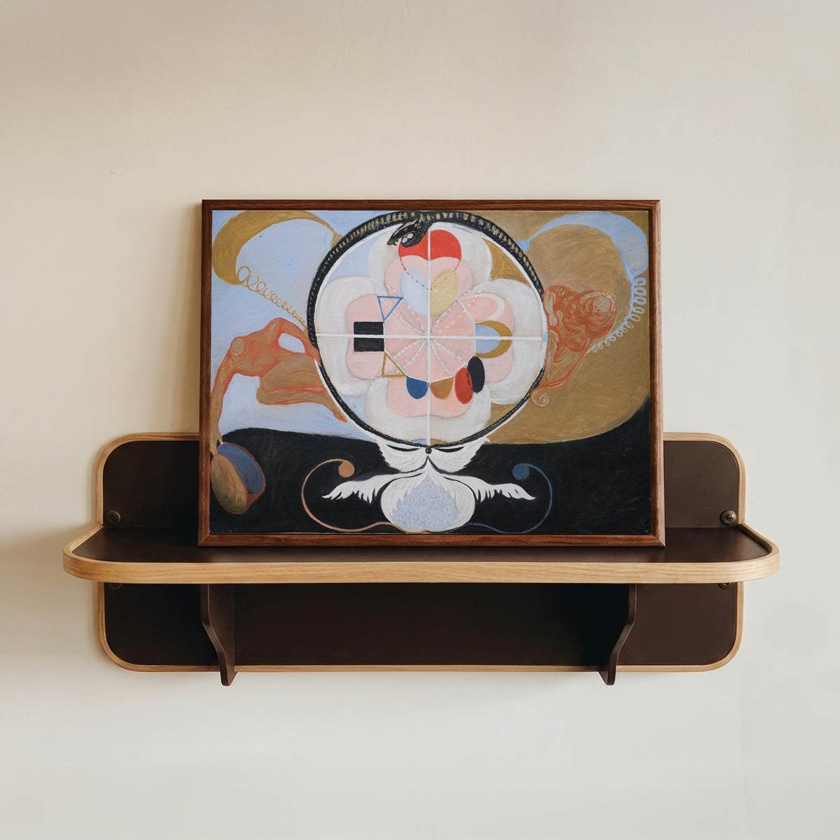 Framed art print of Evolution, No. 13, Group VI by Hilma af Klint, in a dark wood frame resting on a wall shelf
