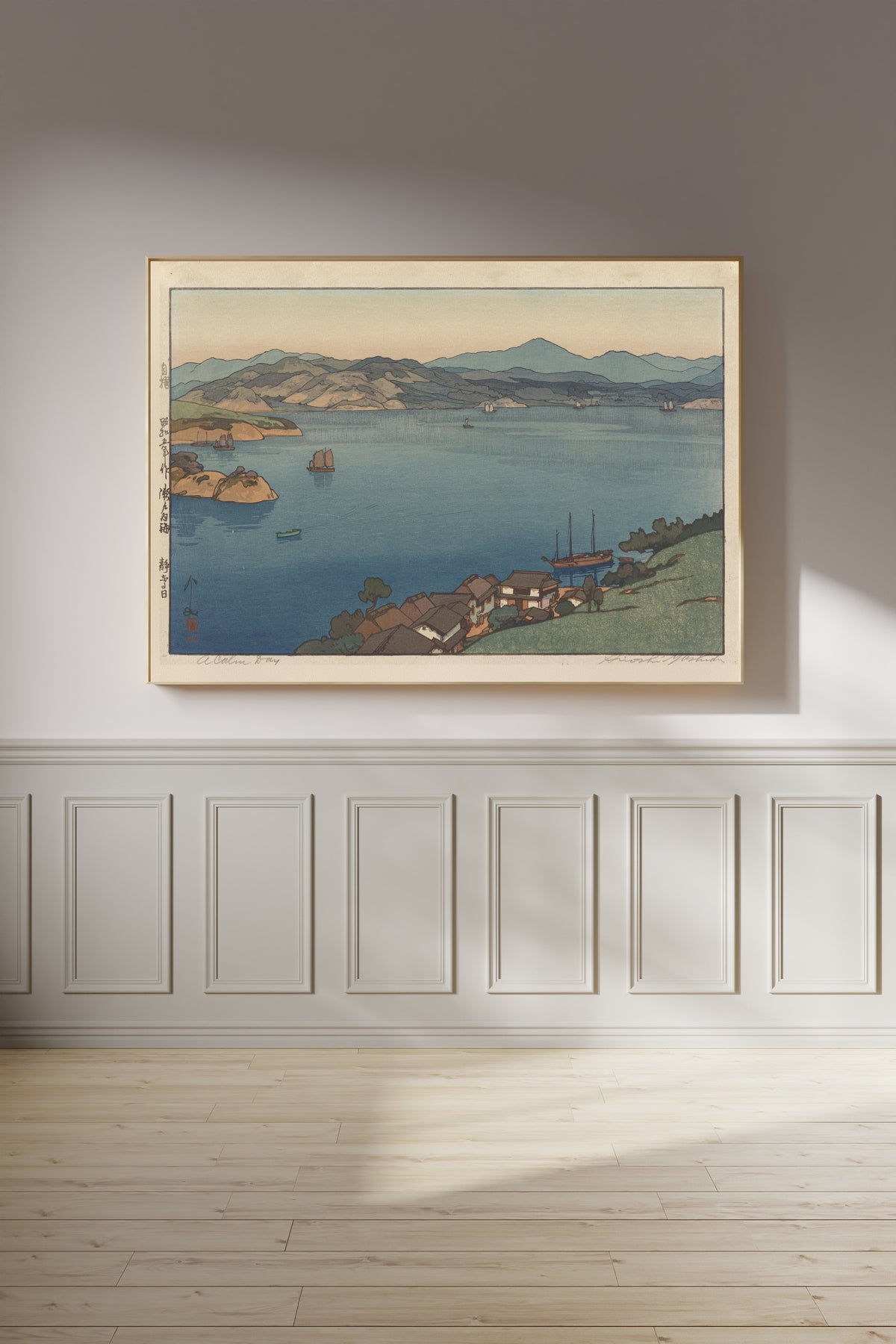 Framed art print of A Calm Day by Hiroshi Yoshida, on a panelled wall in afternoon light