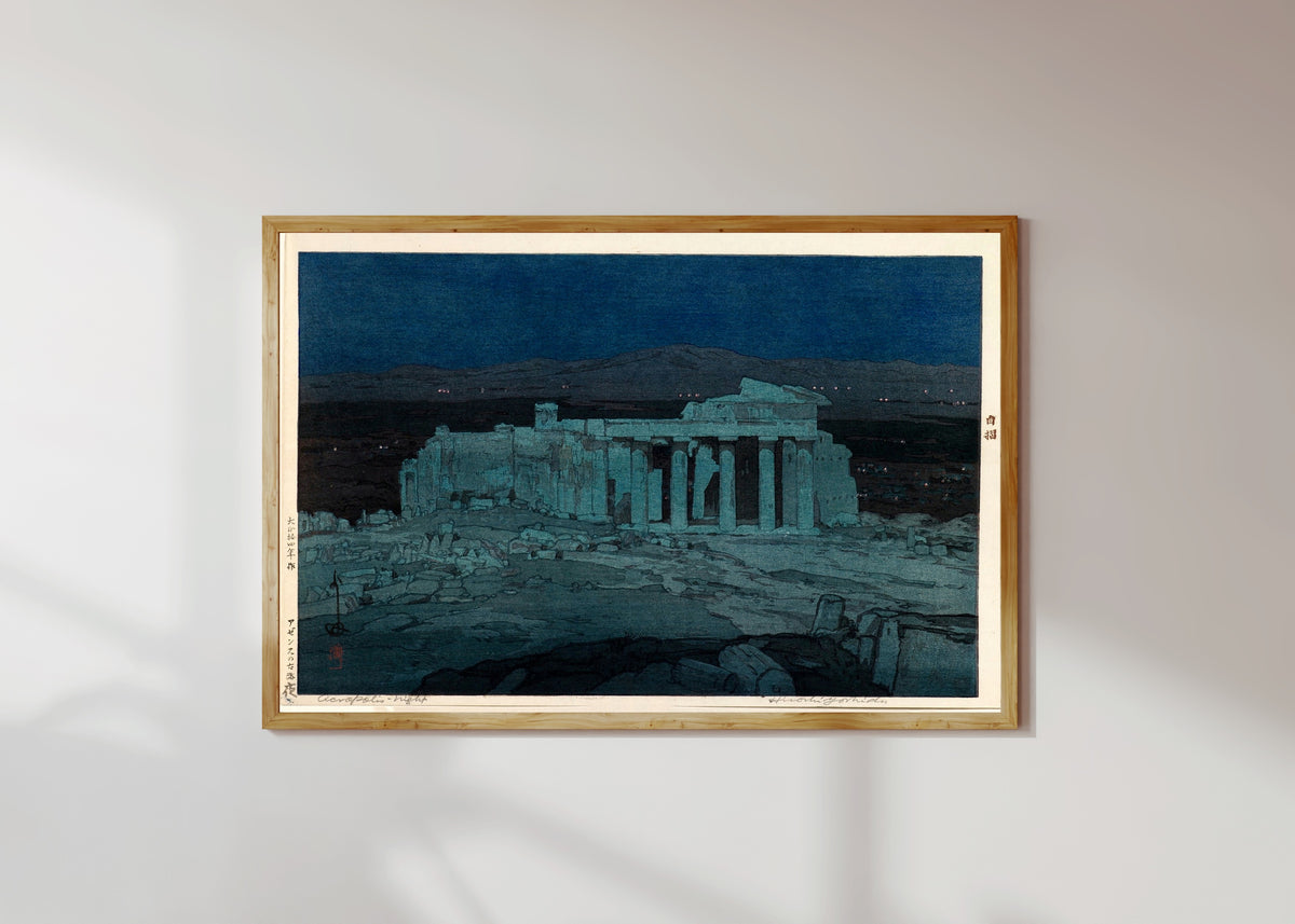 Framed art print of Ancient Ruins of Athens by Hiroshi Yoshida, in a light wood frame on a sunlit white wall