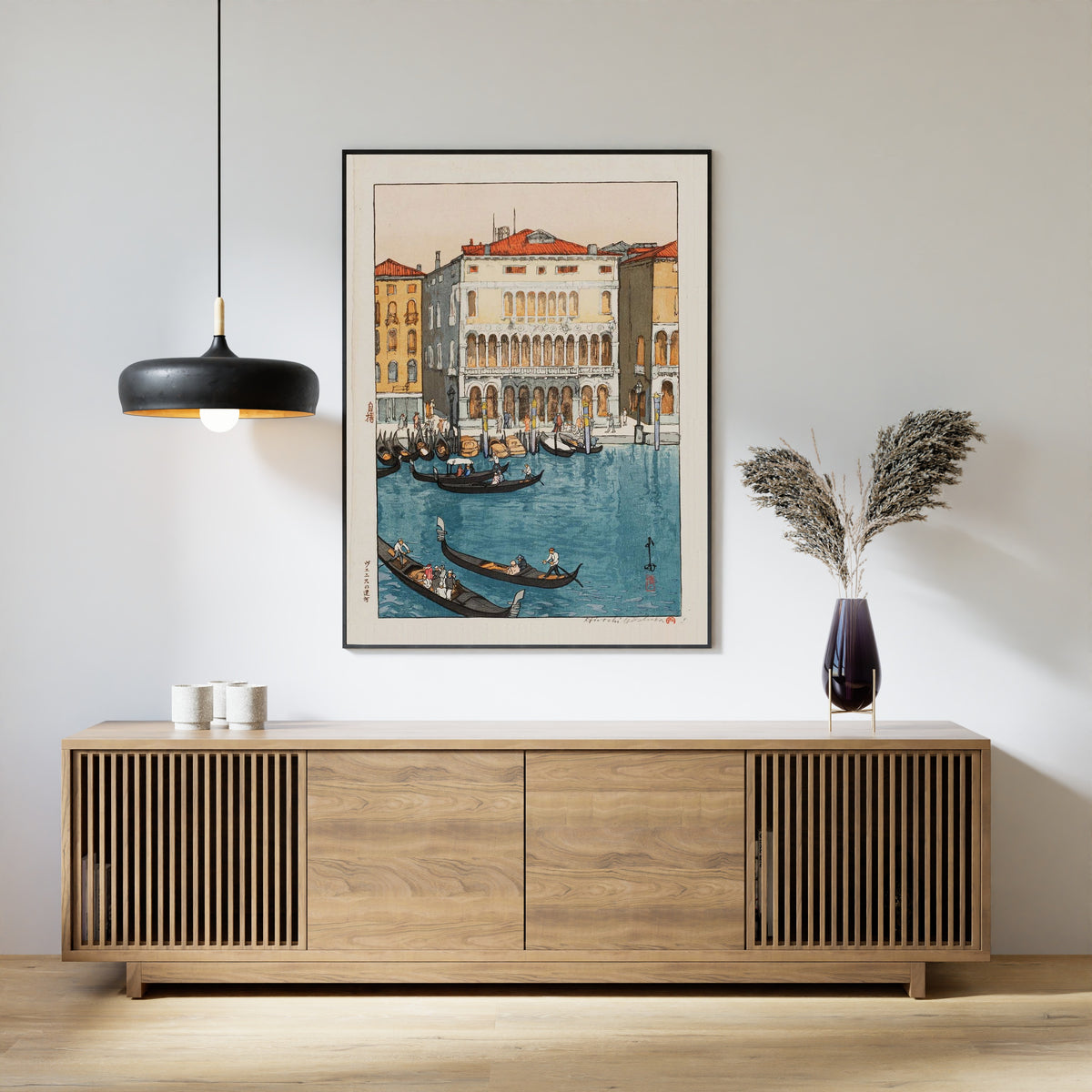 Framed art print of Canal in Venice by Hiroshi Yoshida, above a slatted wood sideboard
