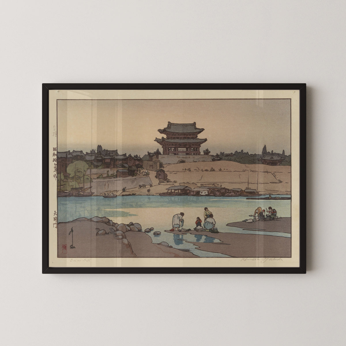 Framed art print of Daidomon (Taedong Gate), Pyongyang by Hiroshi Yoshida, in a black frame on a pale wall