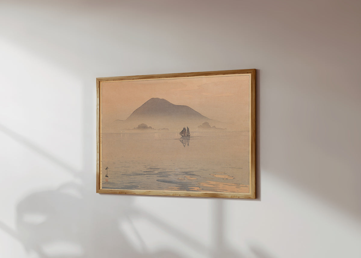 Framed art print of Evening After Rain, Inland Sea by Hiroshi Yoshida, in a light wood frame on a sunlit white wall, seen at a slight angle