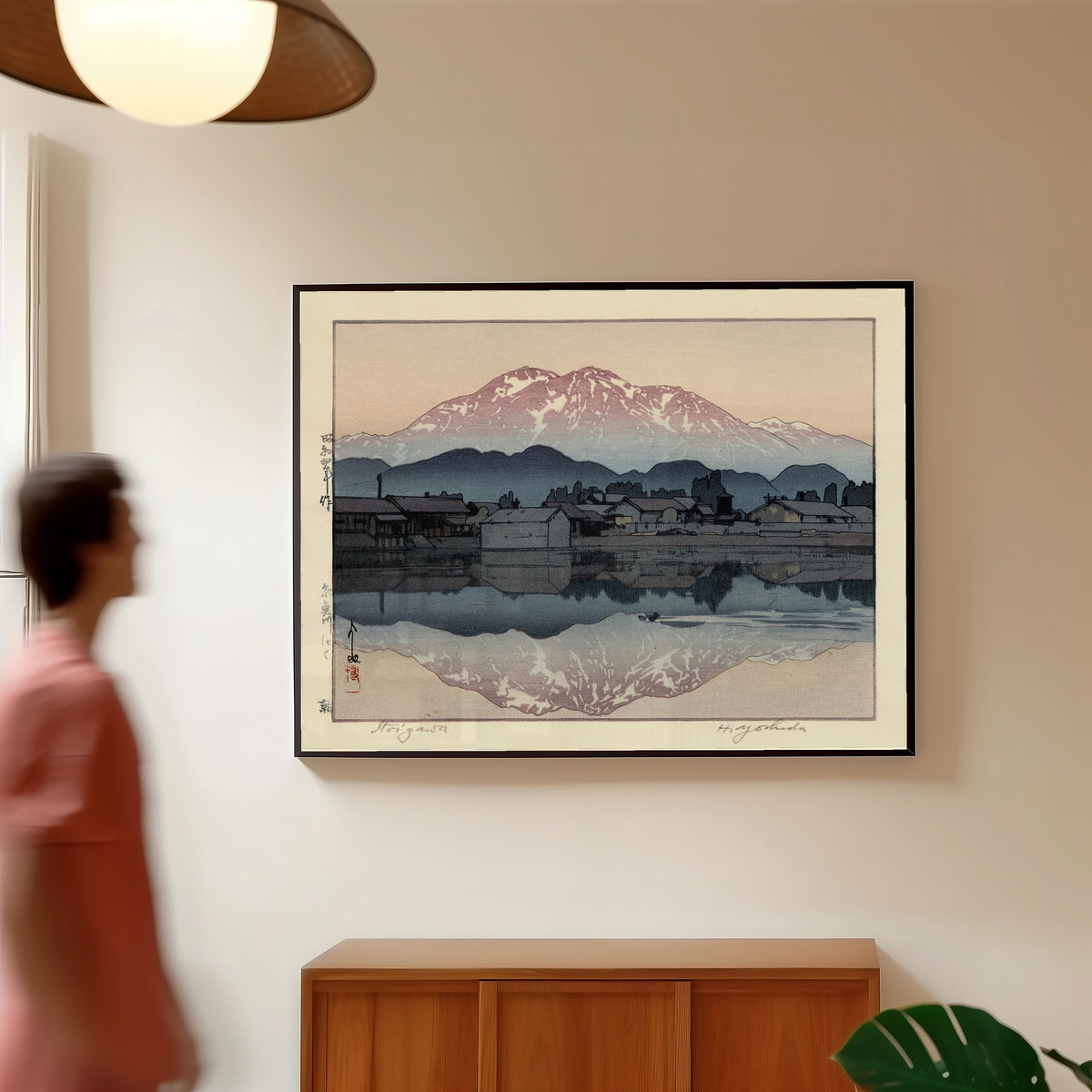 Framed art print of Itoigawa Morning by Hiroshi Yoshida, in a slim black frame on a warm wall in a sunlit room