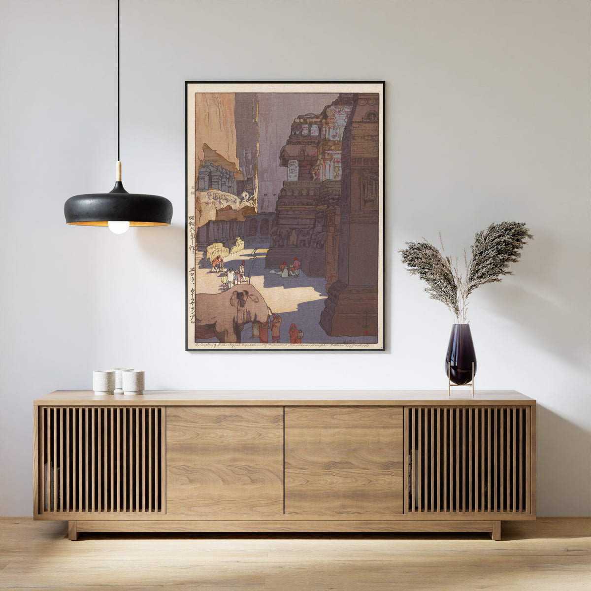 Framed art print of Kailasa Temple at Ellora by Hiroshi Yoshida, above a slatted wood sideboard