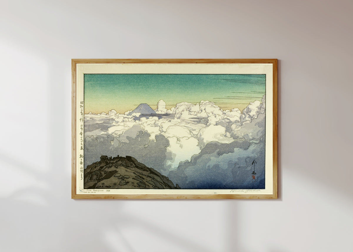 Framed art print of Komagatake Mountain by Hiroshi Yoshida, in a light wood frame on a sunlit white wall