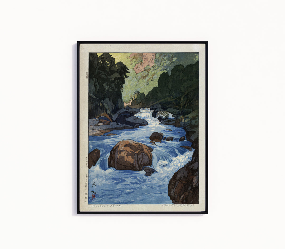 Framed art print of Kurobe River by Hiroshi Yoshida, in a slim black frame on a plain white wall