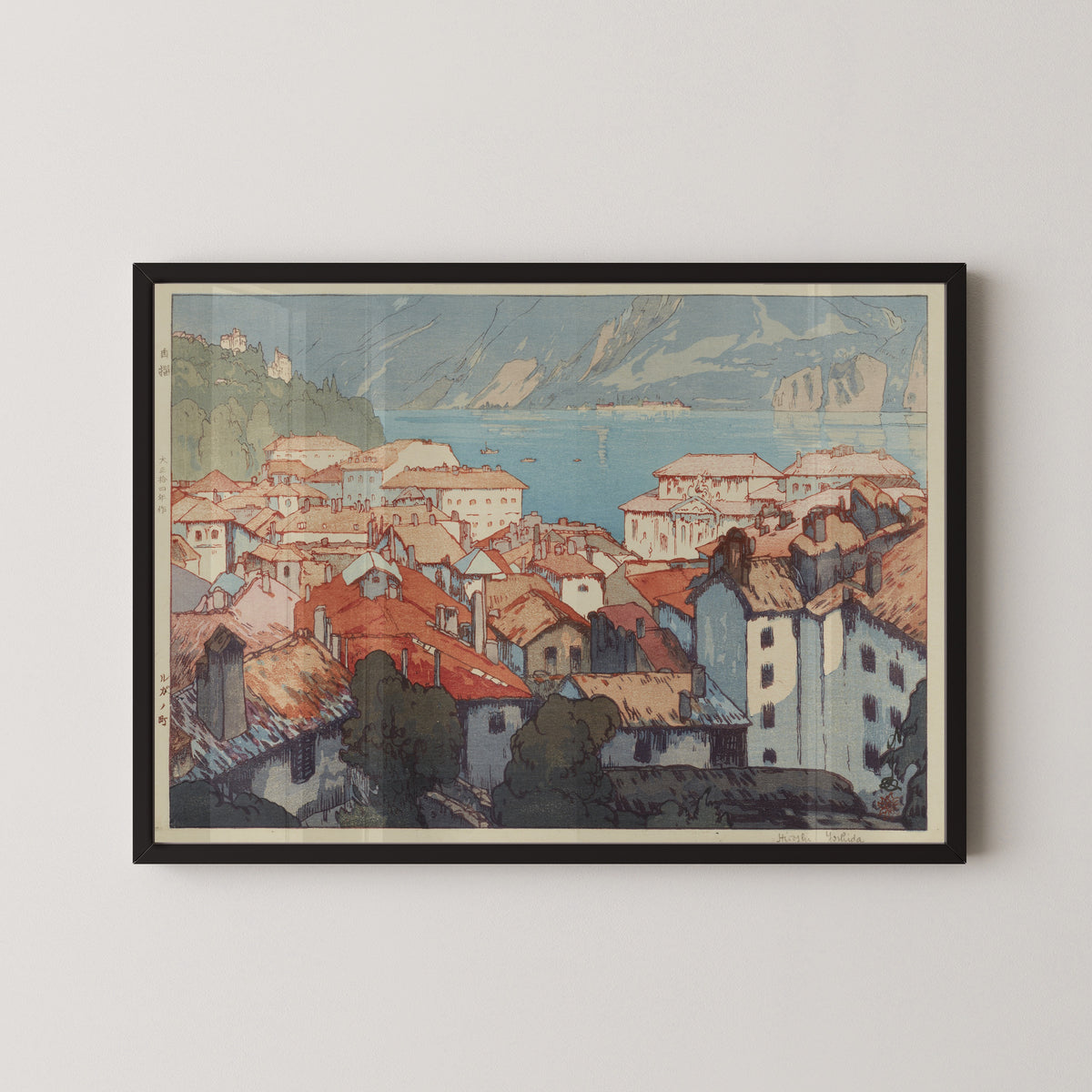 Framed art print of Lugano by Hiroshi Yoshida, in a black frame on a pale wall