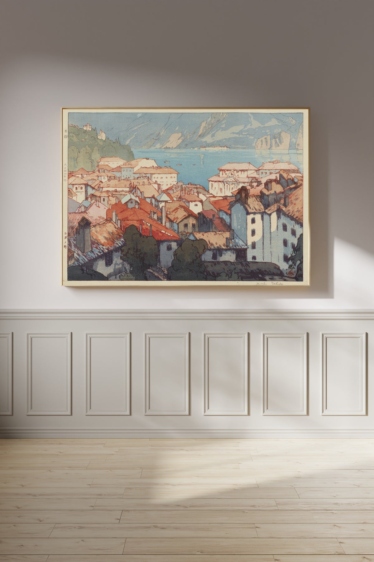 Framed art print of Lugano by Hiroshi Yoshida, on a panelled wall in afternoon light