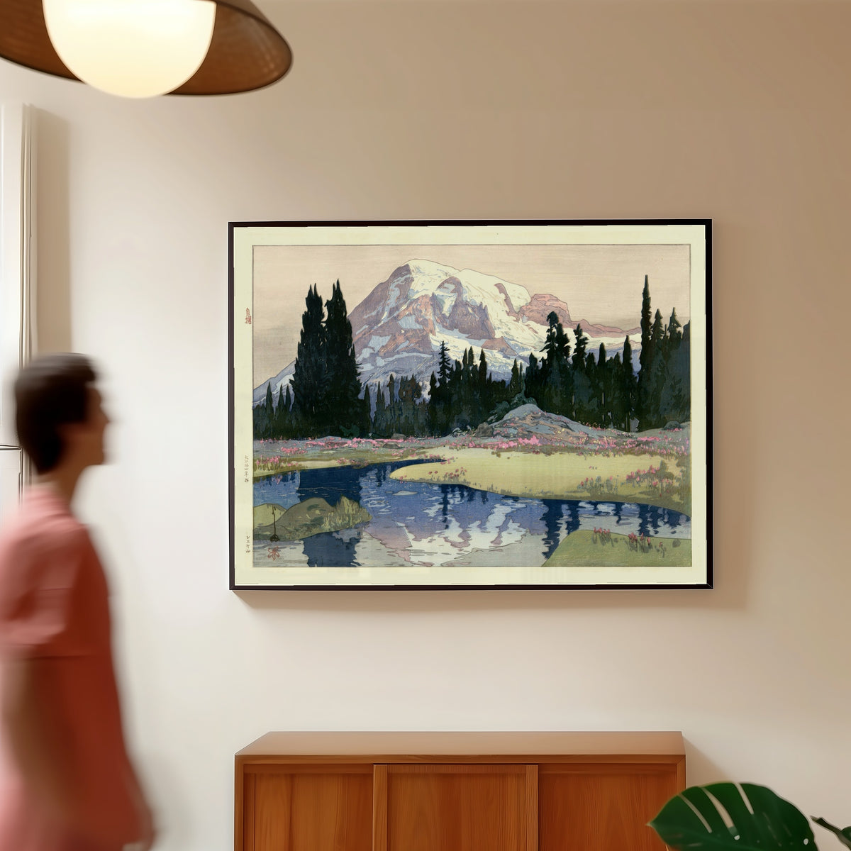Framed art print of Mount Rainier, Washington State by Hiroshi Yoshida, in a slim black frame on a warm wall in a sunlit room