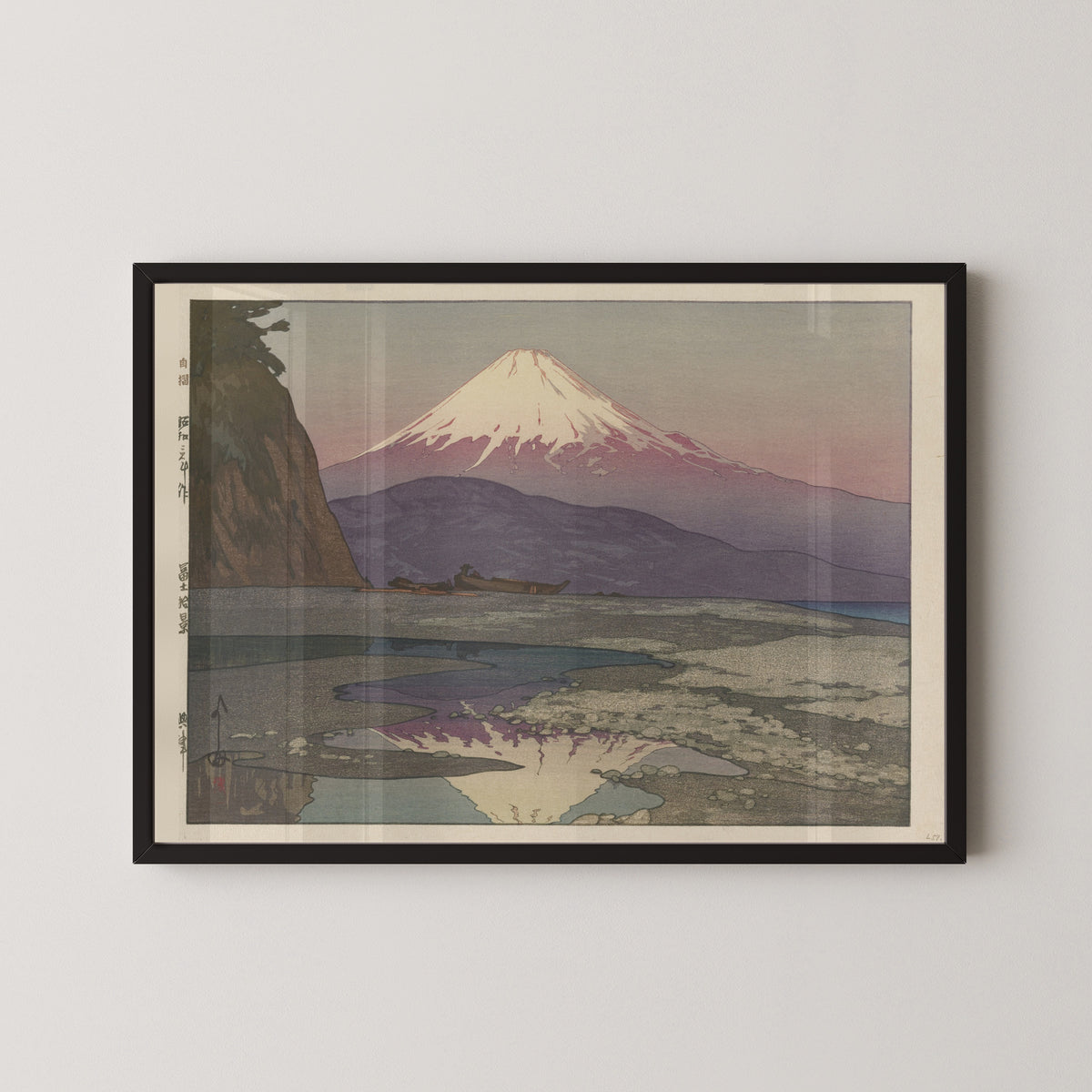 Framed art print of Okitsu by Hiroshi Yoshida, in a black frame on a pale wall