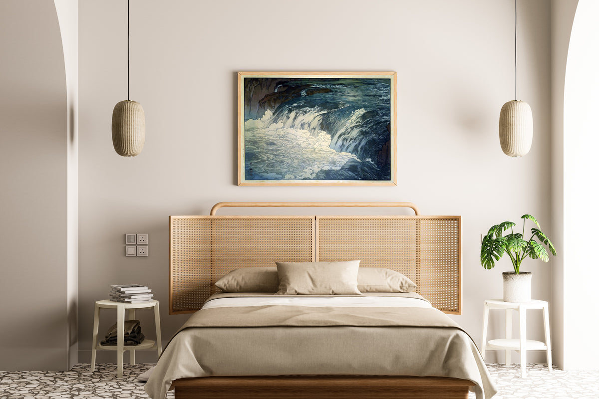 Framed art print of Rapids by Hiroshi Yoshida, above a cane-headboard bed