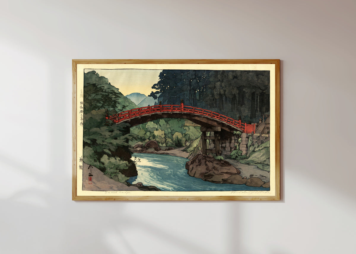 Framed art print of Sacred Bridge by Hiroshi Yoshida, in a light wood frame on a sunlit white wall