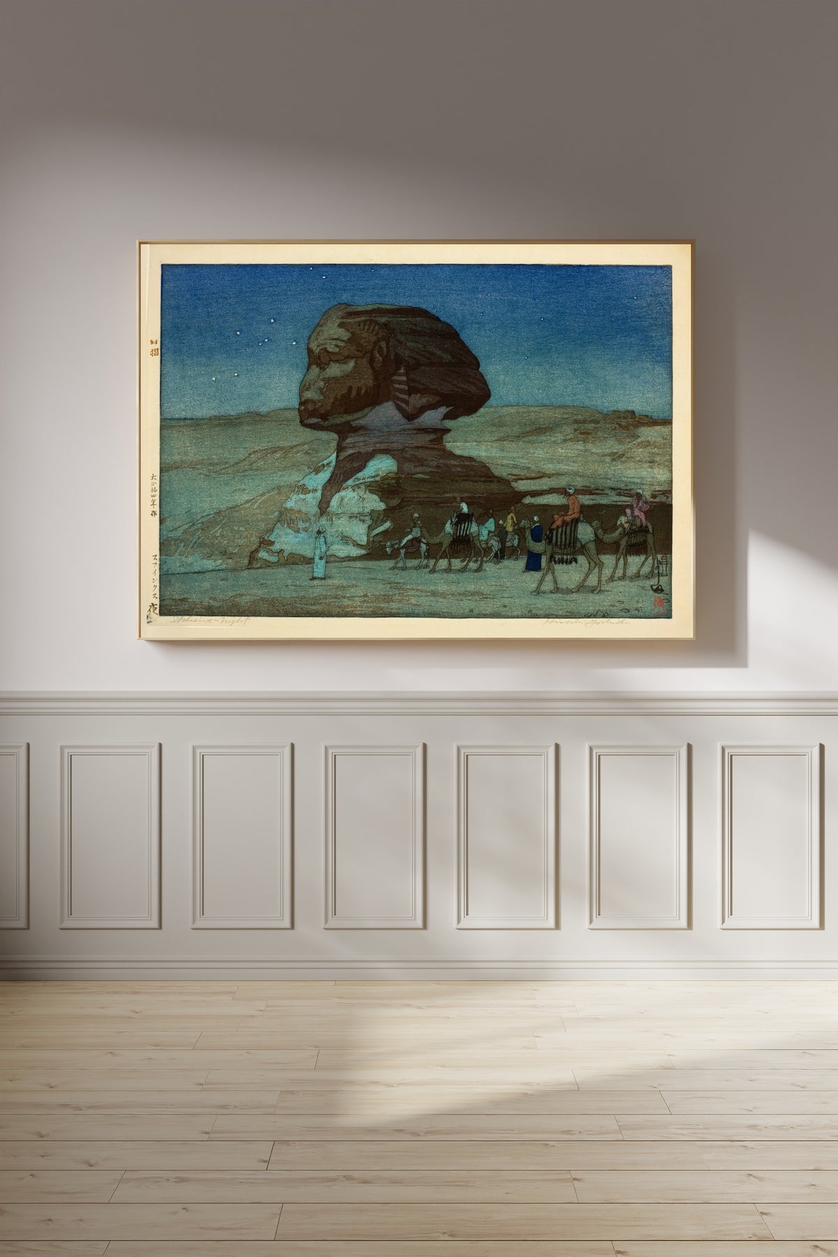 Framed art print of Sphinx at Night by Hiroshi Yoshida, on a panelled wall in afternoon light
