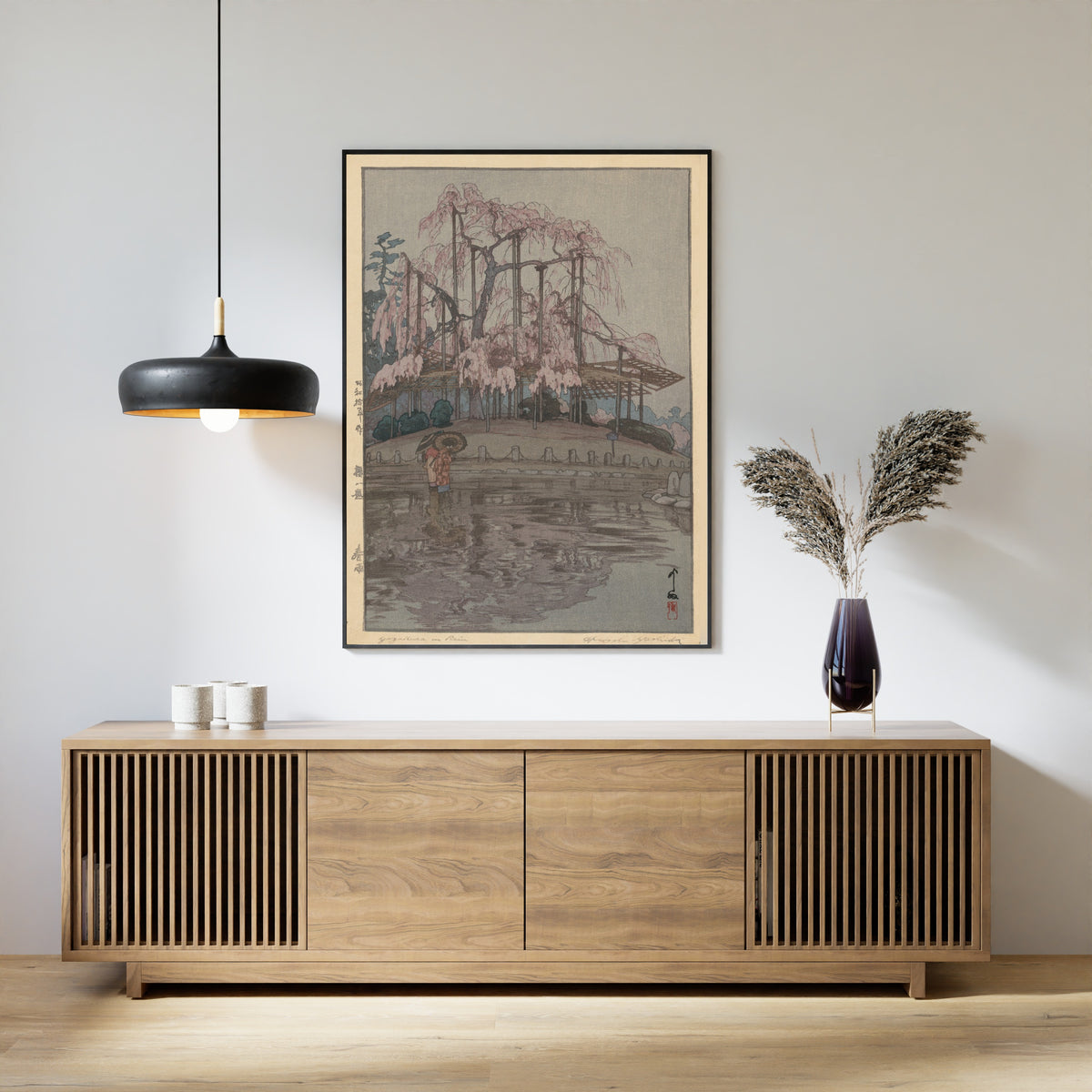 Framed art print of Spring Rain, from Eight Scenes of Cherry Blossoms by Hiroshi Yoshida, above a slatted wood sideboard