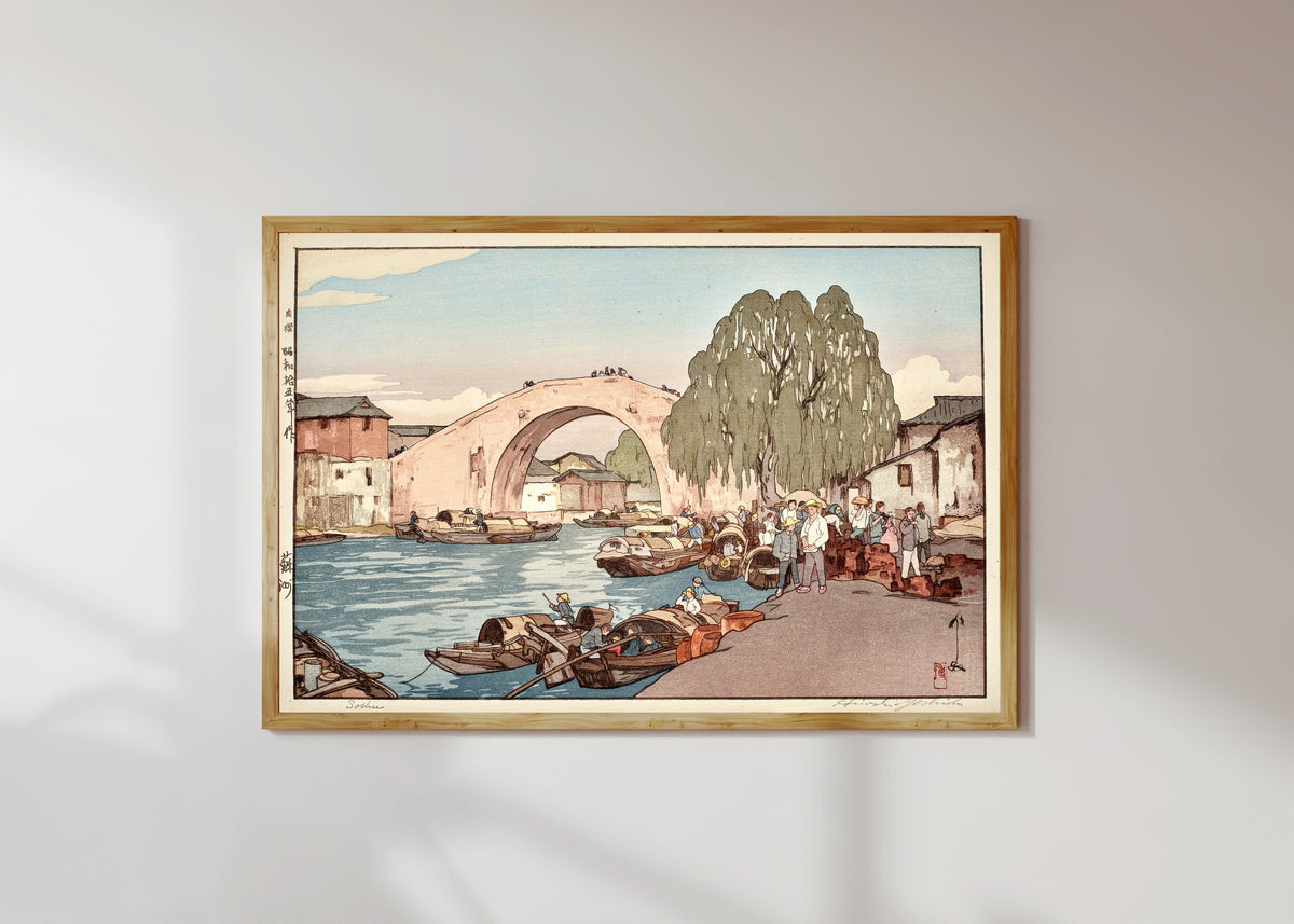 Framed art print of Suzhou by Hiroshi Yoshida, in a light wood frame on a sunlit white wall
