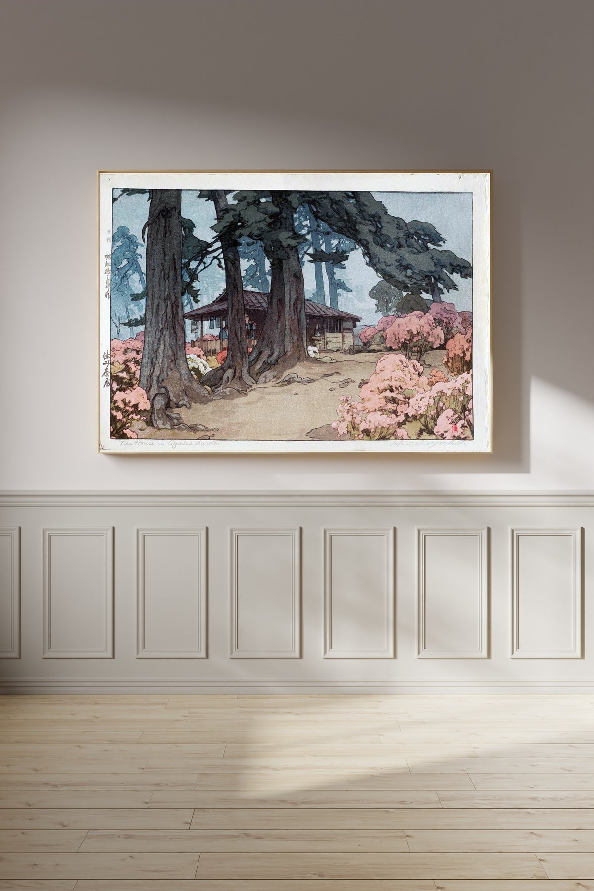 Framed art print of Tea House in Azalea Garden by Hiroshi Yoshida, on a panelled wall in afternoon light