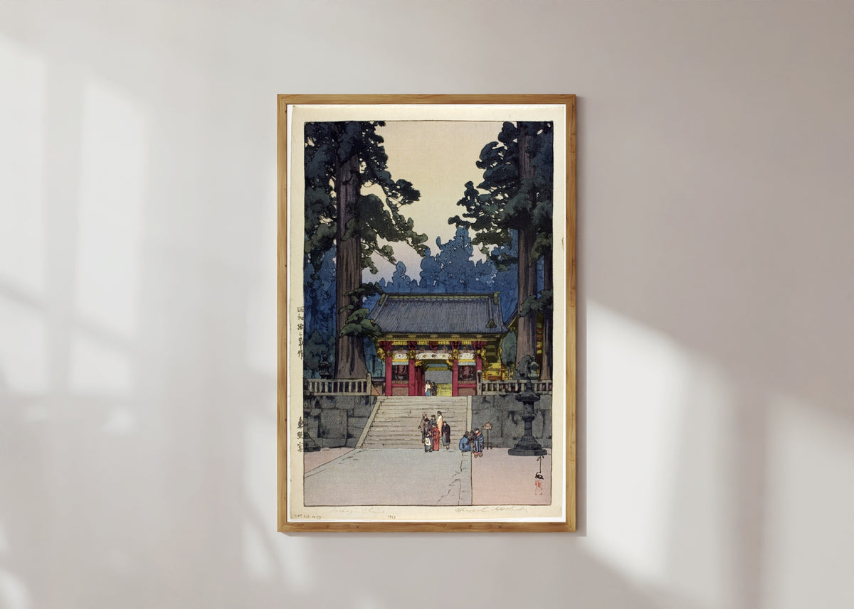 Framed art print of Toshogu Shrine by Hiroshi Yoshida, in a light wood frame on a sunlit white wall