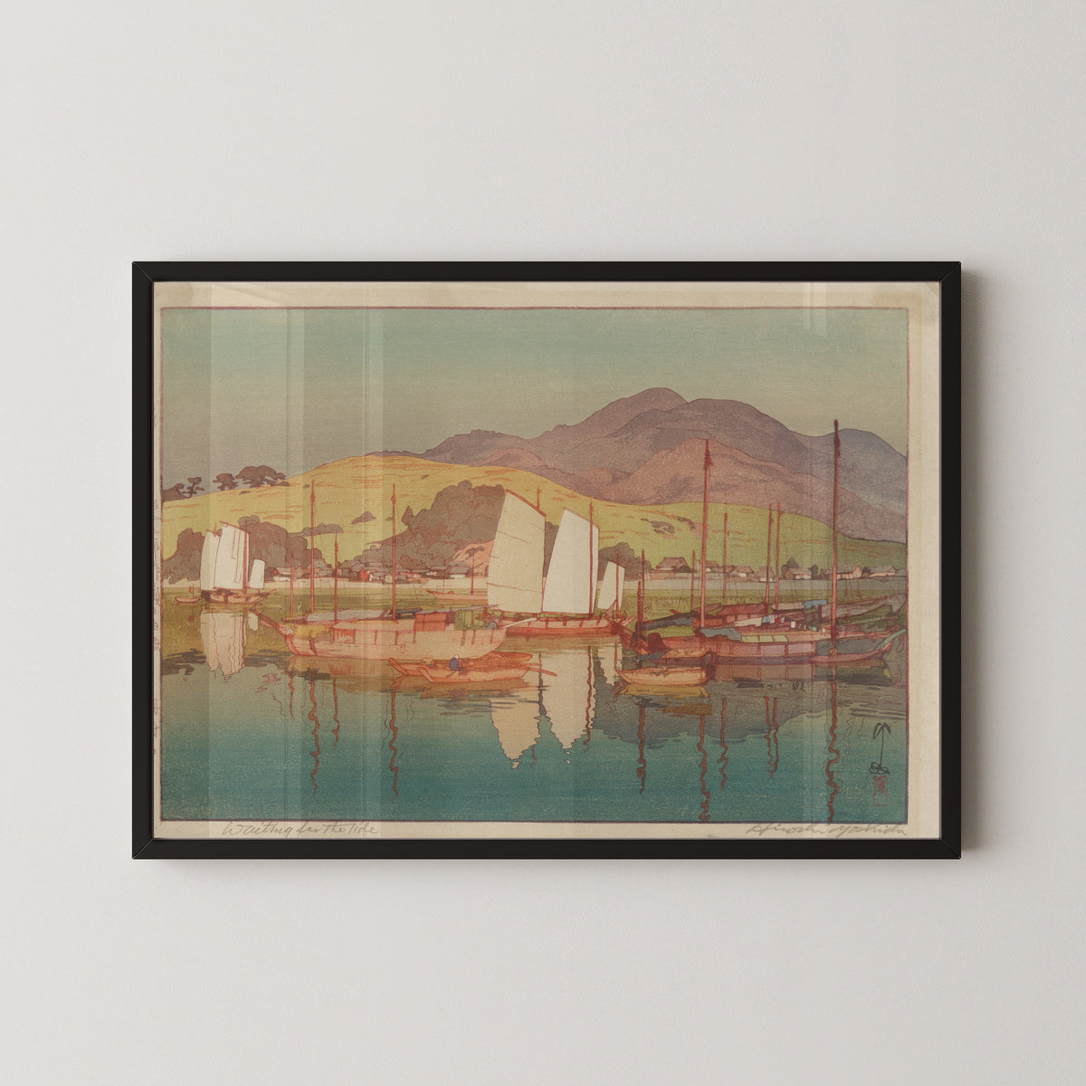 Framed art print of Waiting for the Tide by Hiroshi Yoshida, in a black frame on a pale wall