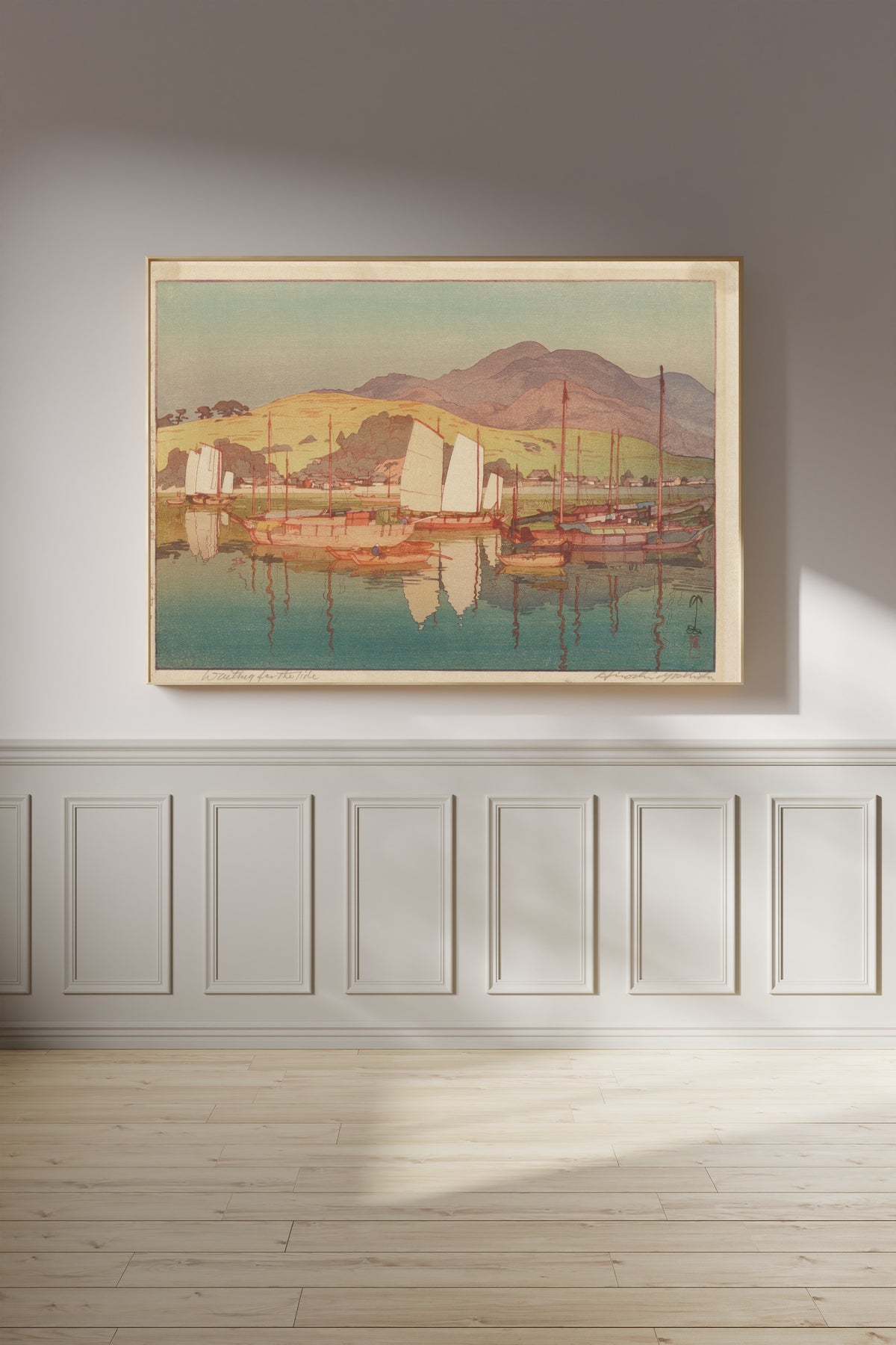 Framed art print of Waiting for the Tide by Hiroshi Yoshida, on a panelled wall in afternoon light