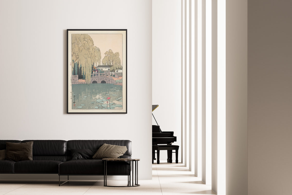 Framed art print of Willow and Stone Bridge by Hiroshi Yoshida, on the wall of a minimal living room
