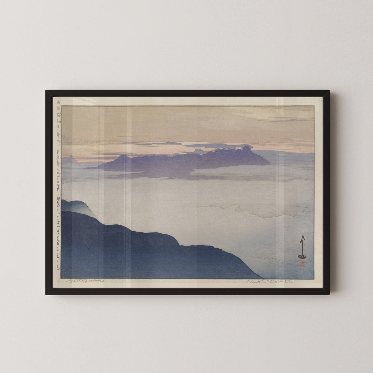Framed art print of Yatsugatake after Rain by Hiroshi Yoshida, in a black frame on a pale wall