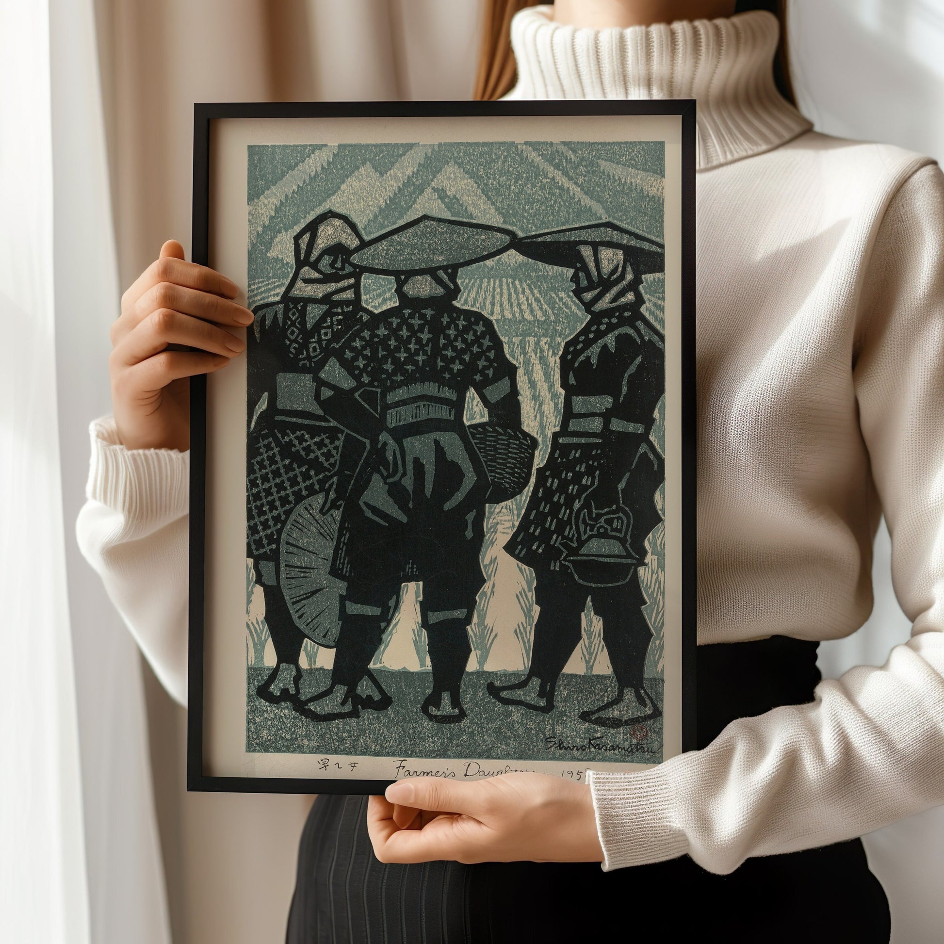 Woman holding Shiro Kasamatsu's "Farmer's Daughters" framed vintage Japanese woodblock art in blue, showcasing fine craftsmanship.