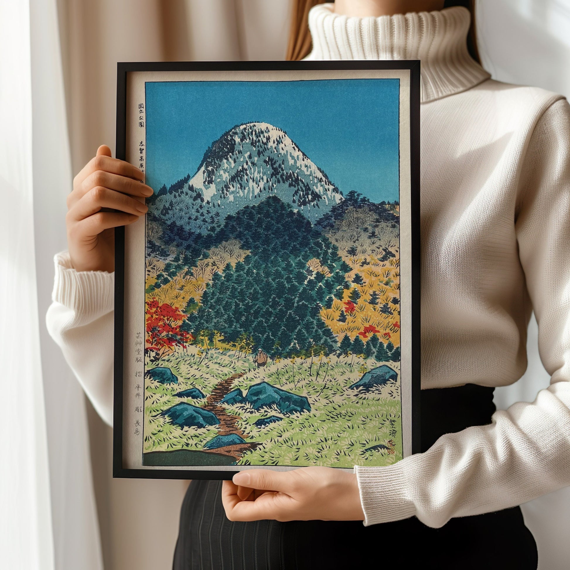 Woman holding framed Shin-Hanga art print of Mount Kasugatake in Shiga by Shiro Kasamatsu, available framed or unframed.