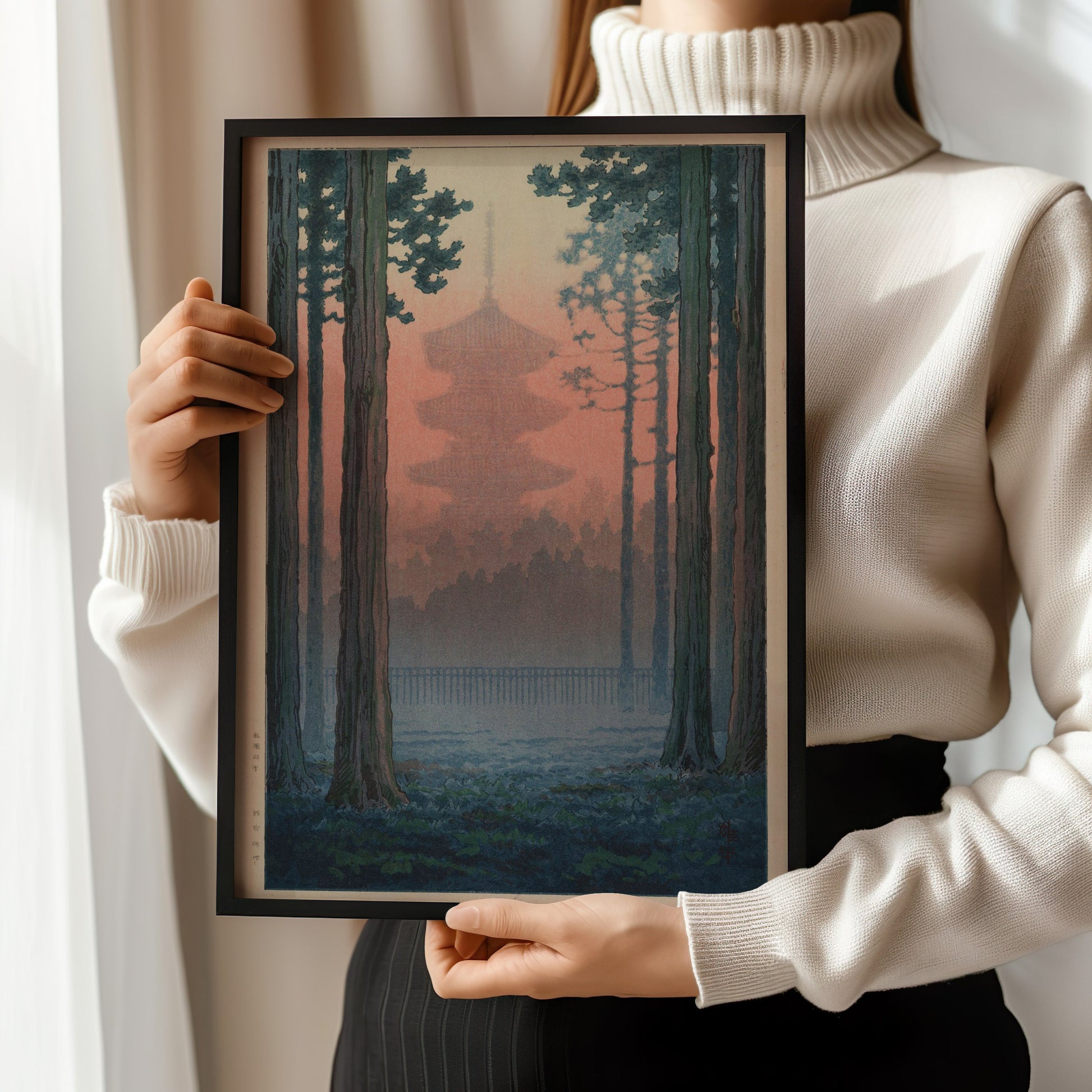 Woman holding framed vintage Japanese woodblock print of a torii gate in a bamboo grove by Ito Yuhan, museum-quality fine art.