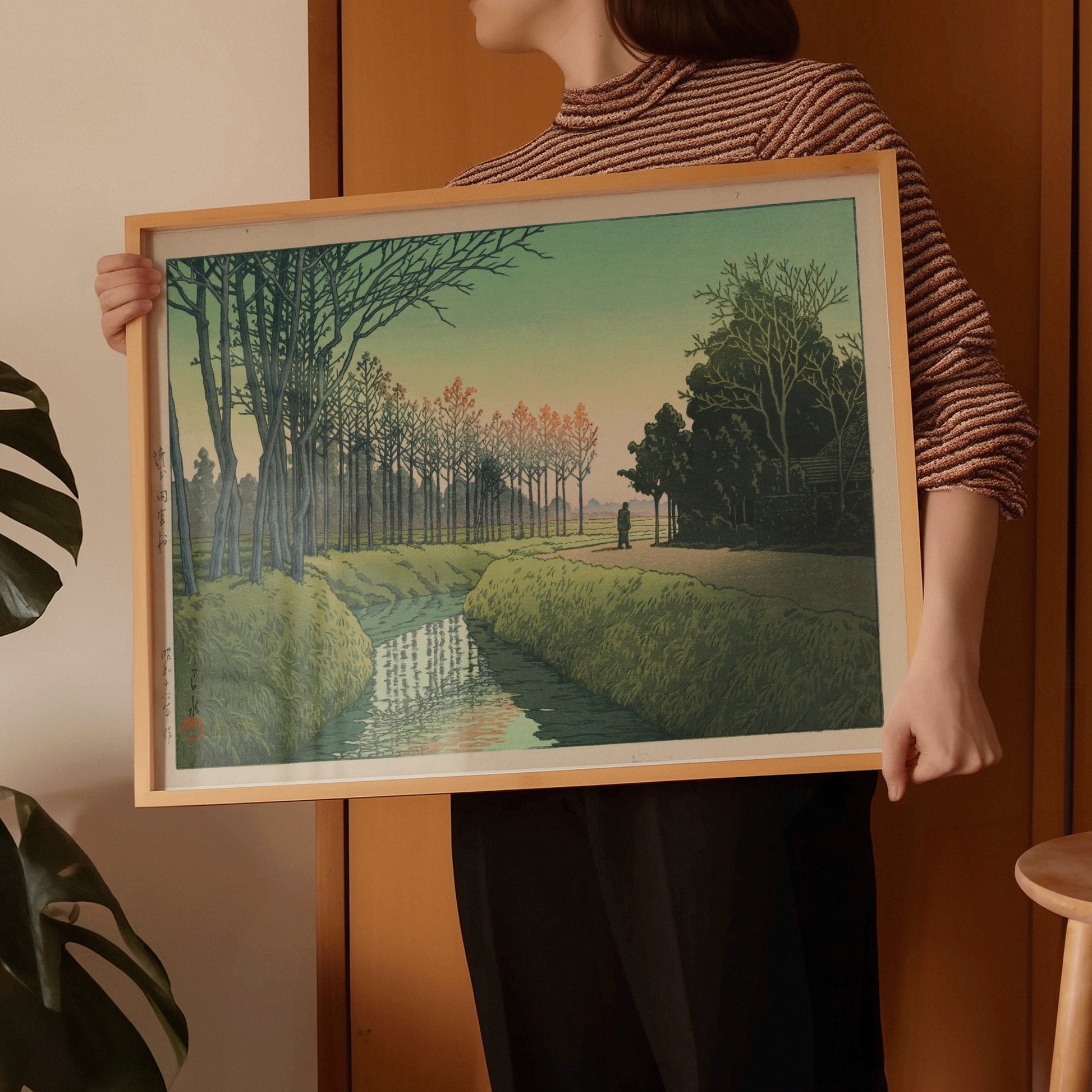 "Kawase Hasui Tamiya Village framed print in oak wood held by person, vintage Japanese woodblock art for home decor."