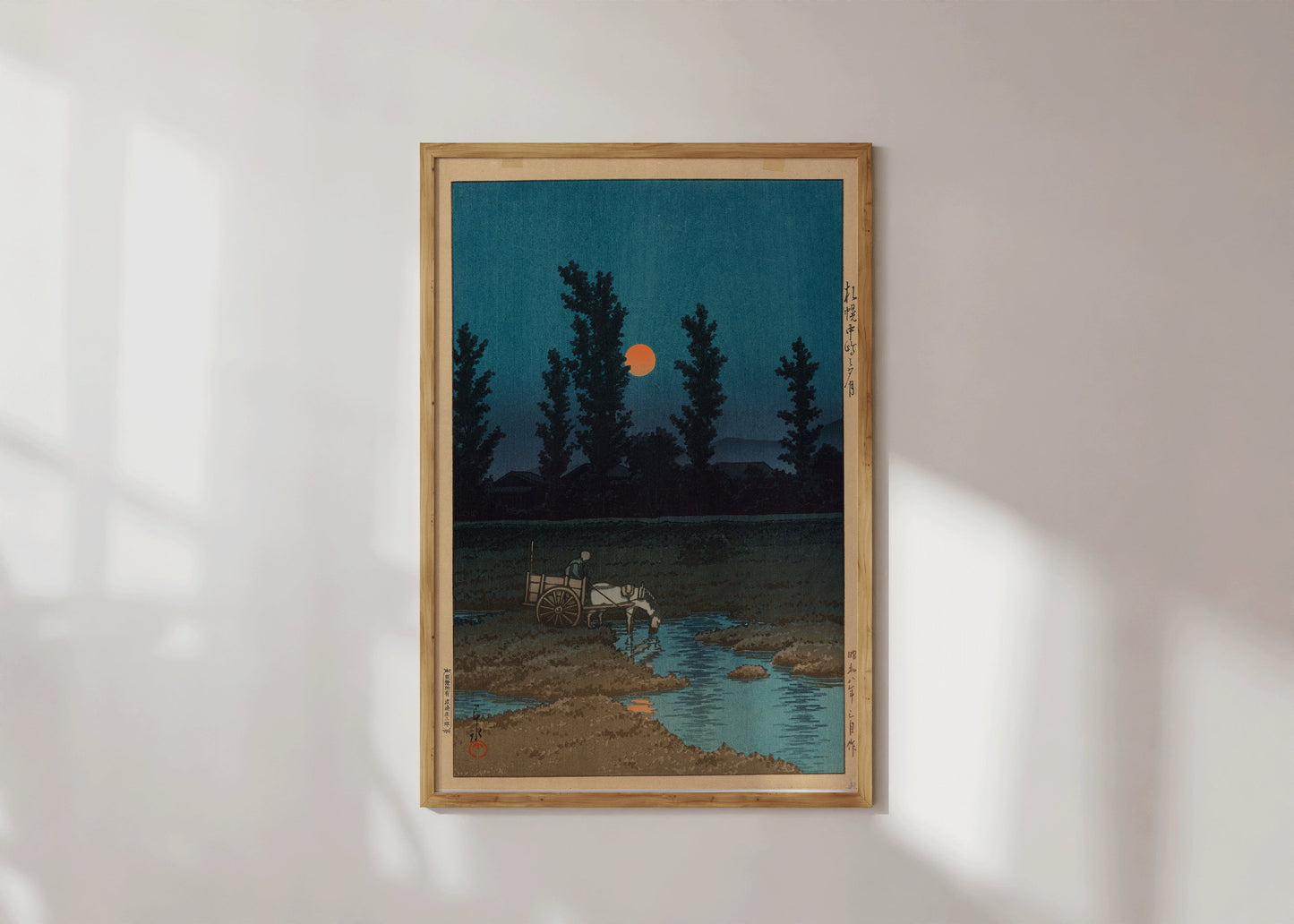 "Kawase Hasui Evening Moon framed woodblock print on wall, showcasing vintage Japanese art with trees and moonlit landscape"