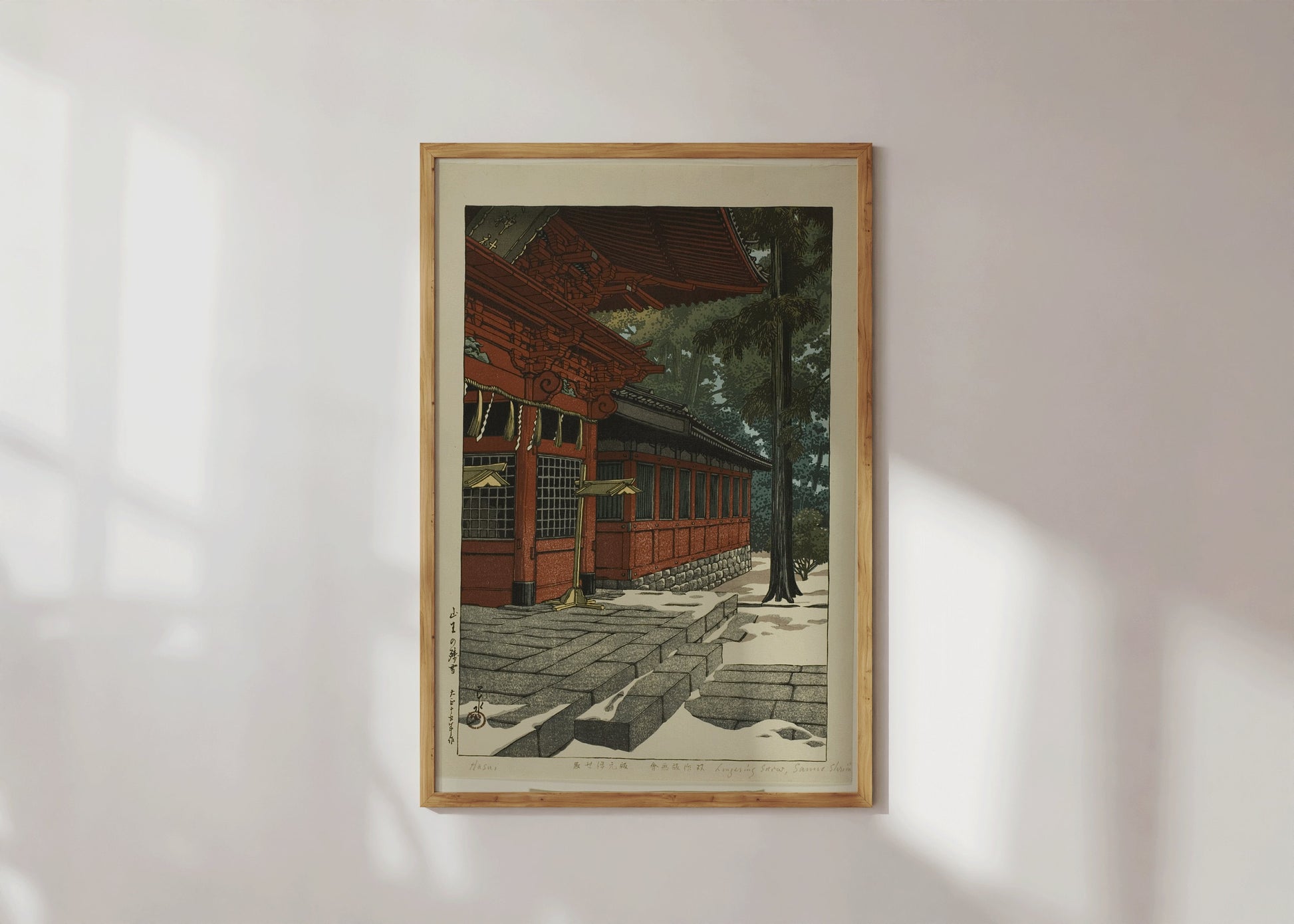 Framed vintage Japanese woodblock art "Lingering Snow at Sanno" by Kawase Hasui displayed on a wall, available in bespoke framing.