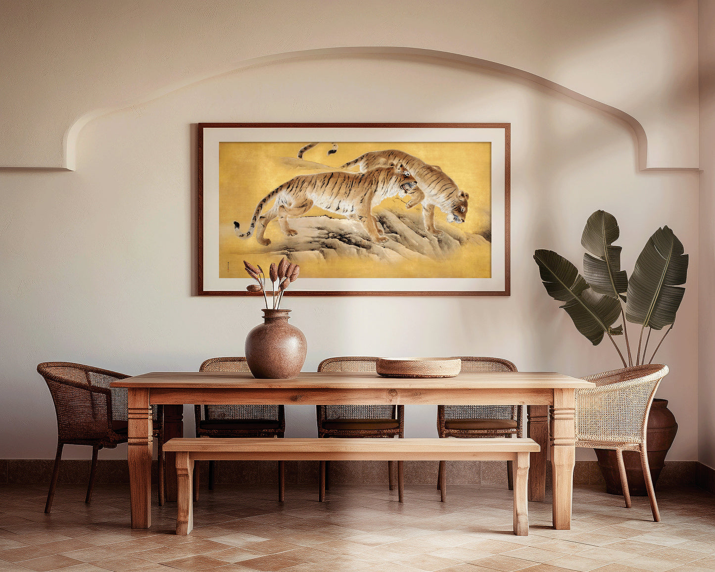 Vintage Japanese art of tigers by a mountain stream in gold, framed on a dining room wall, with wooden furniture and plants.