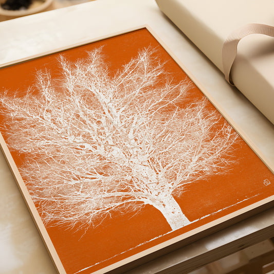 Joichi Hoshi Orange and White Tree woodblock art framed in nude oak on a table, showcasing vintage Japanese art style.