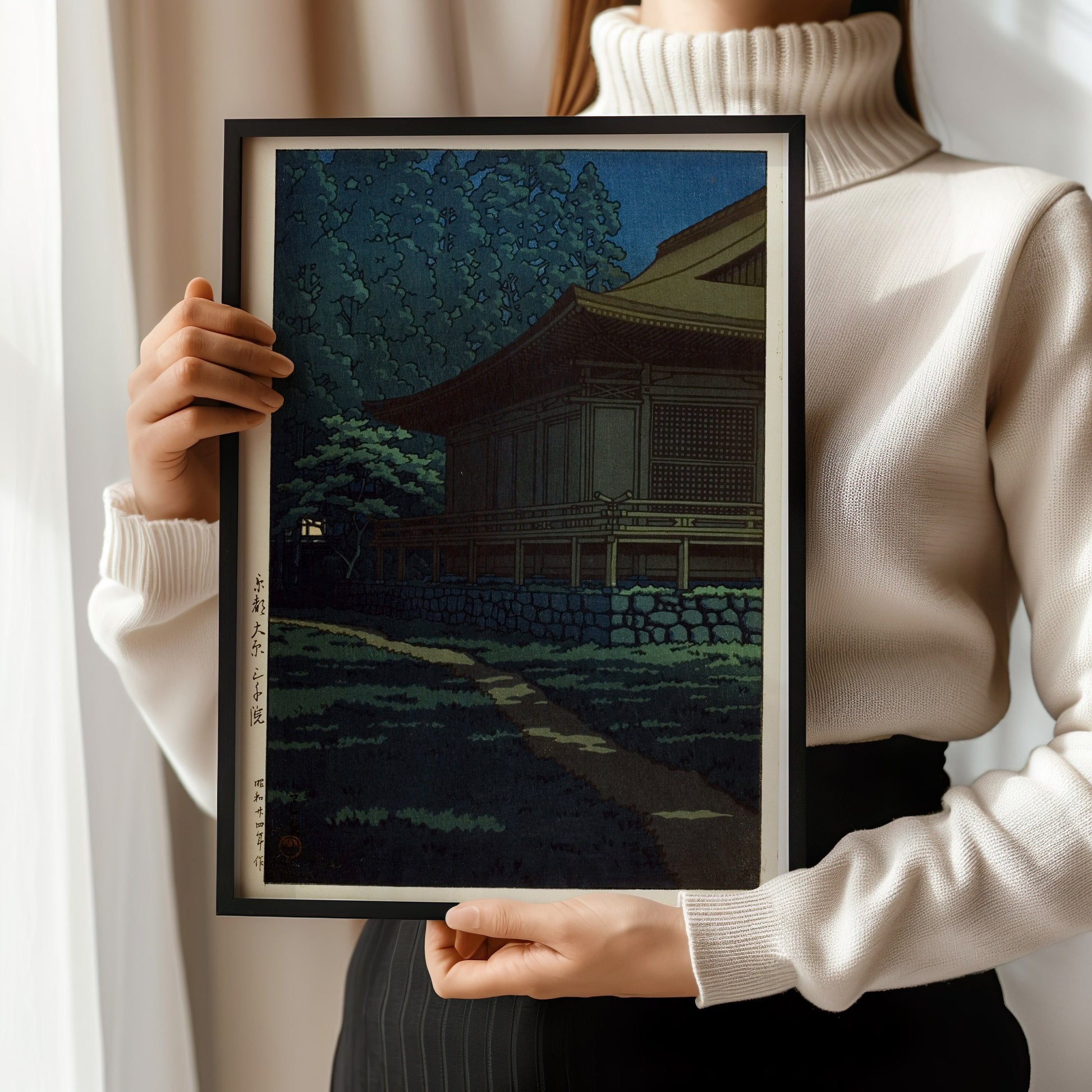 "Kawase Hasui Sanzen Temple print, held by person, showcasing vintage Japanese woodblock art in a black frame."