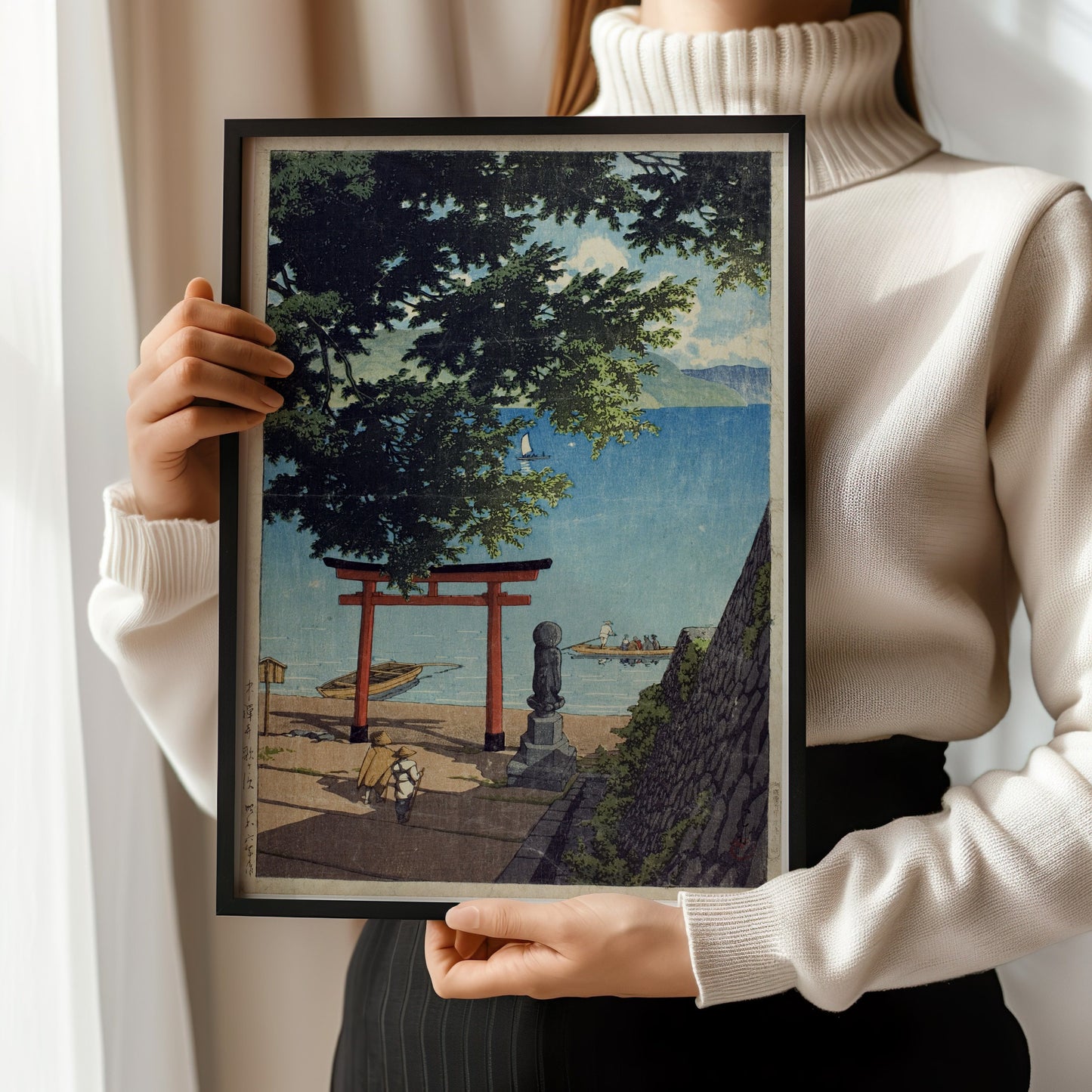 Woman holding framed "Chuzenji, Utagahama" vintage Japanese woodblock art by Kawase Hasui; available framed or unframed.