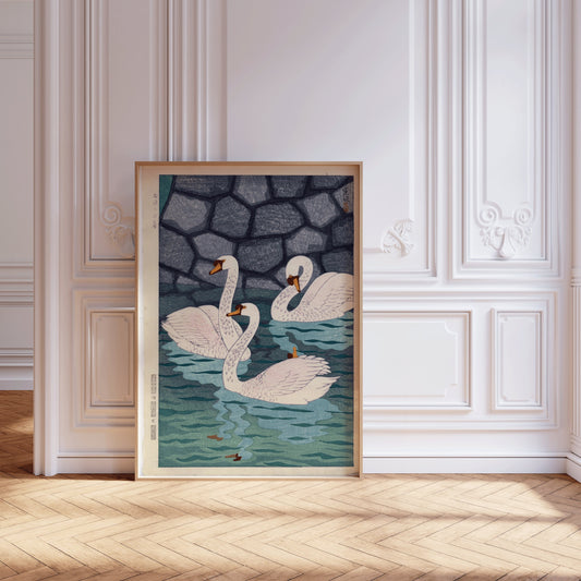 Vintage Japanese woodblock print framed, featuring swans in a moat, displayed in an elegant room with ornate white walls.