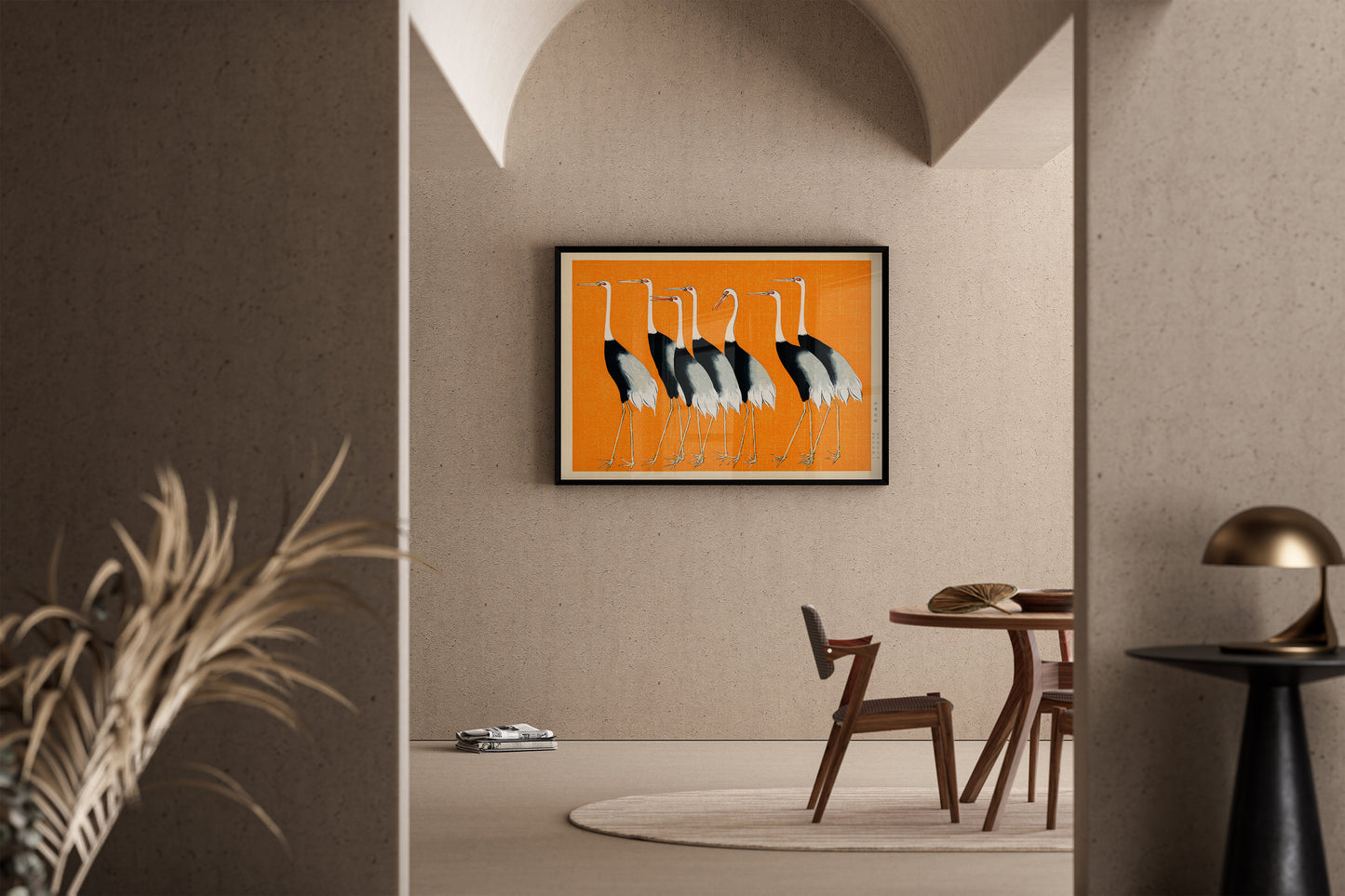 Vintage Japanese art print of cranes in orange, framed in a modern living room setting with elegant decor and wooden furniture.